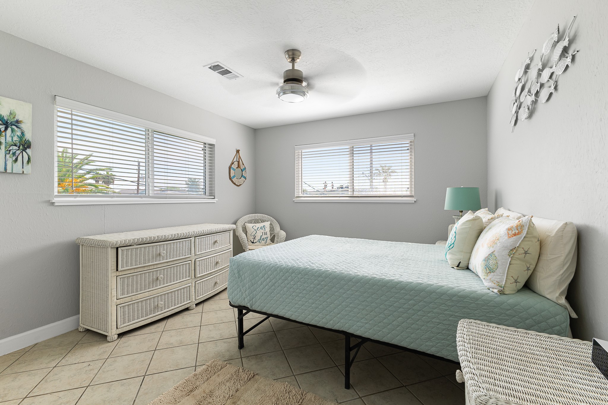 Second bedroom with coastal touches, tile flooring and great natural light.