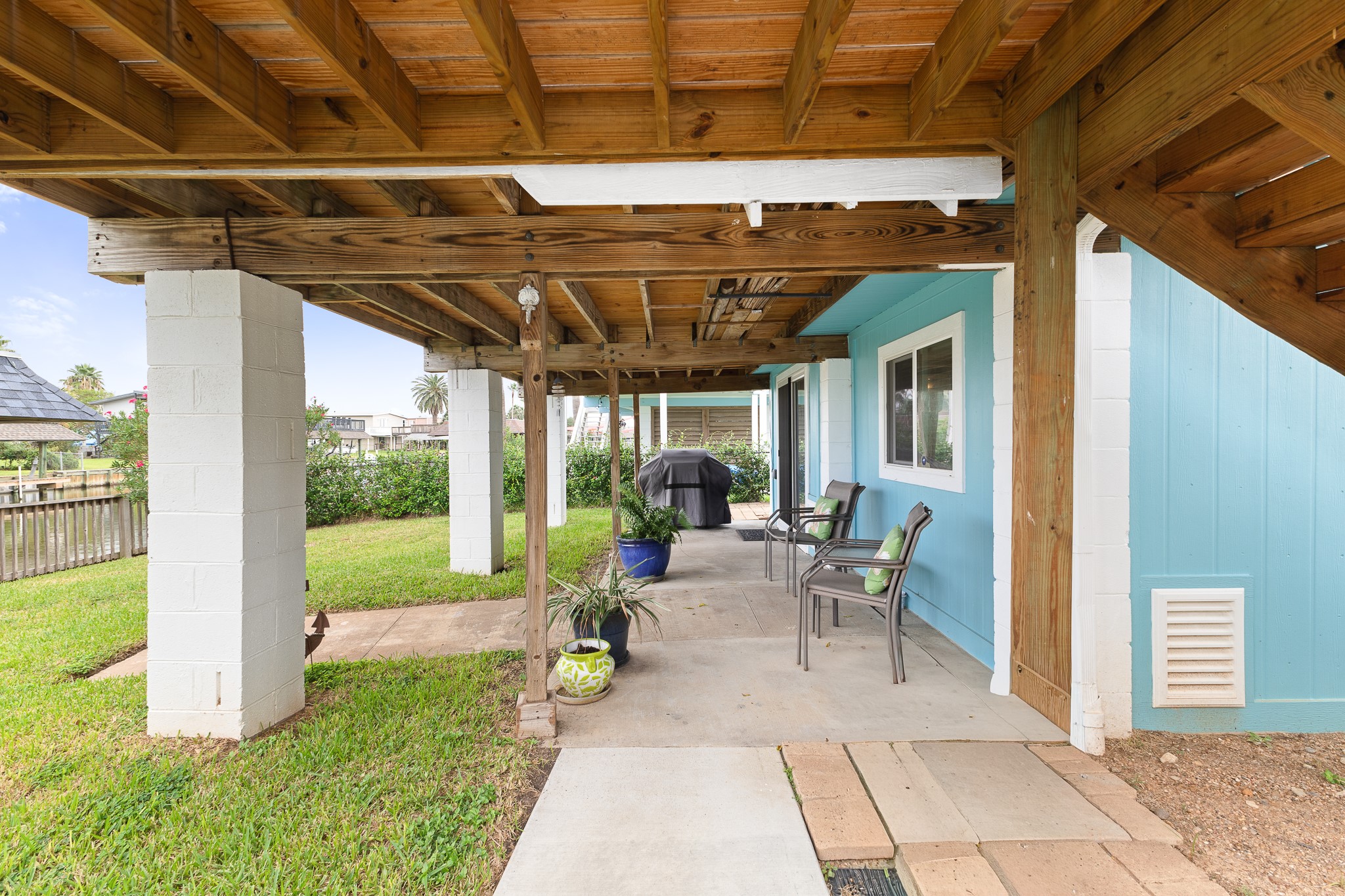 Covered ground-level patio offers additional outdoor living and entertaining space.