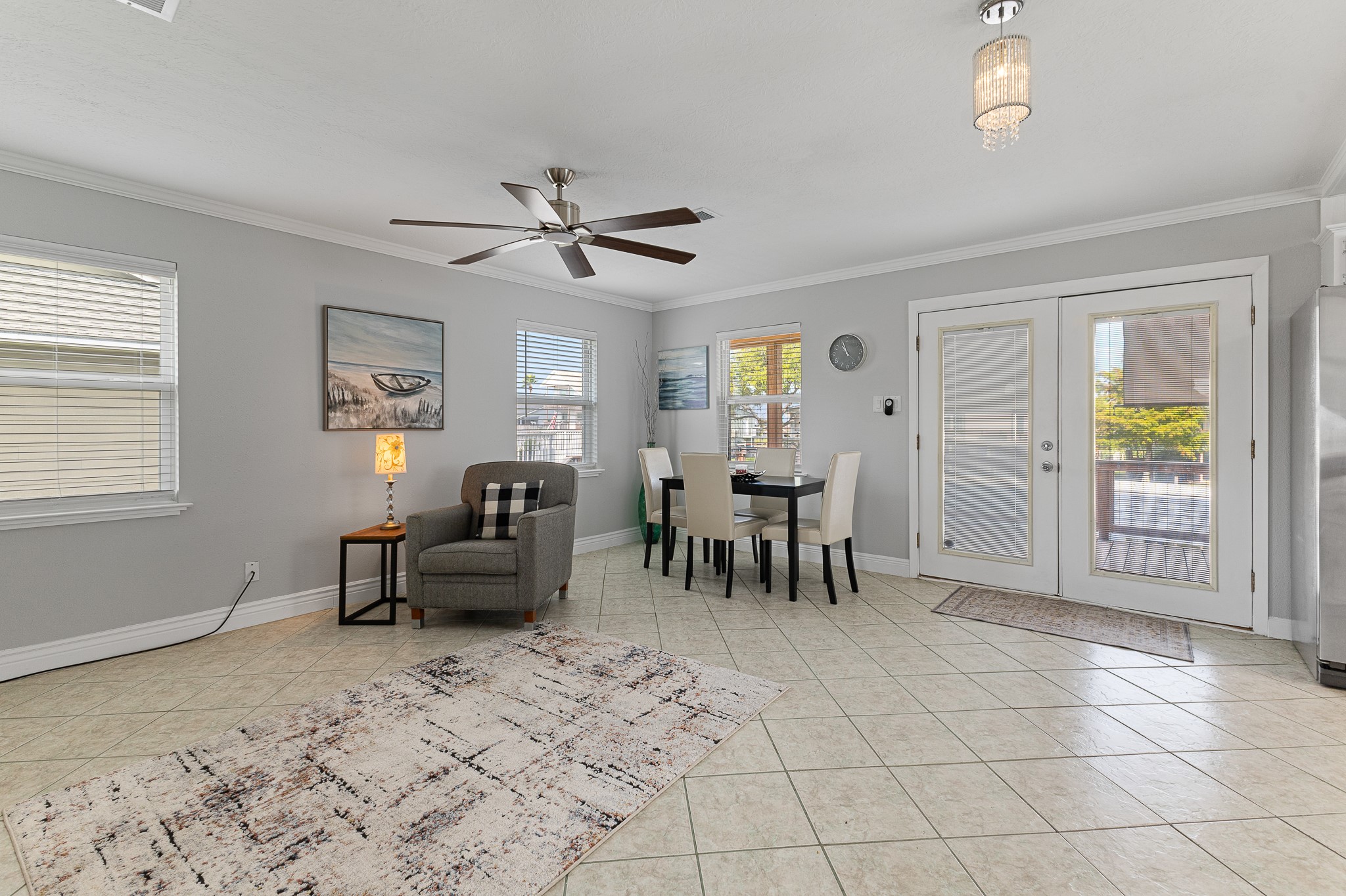 Open living and dining space with French doors leading to the waterfront deck. Open living and dining space with French doors leading to the waterfront deck.