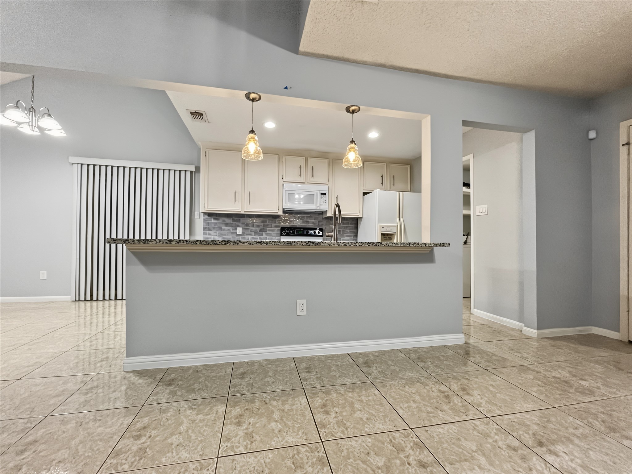 Great view of the open kitchen loaded with granite countertops.
