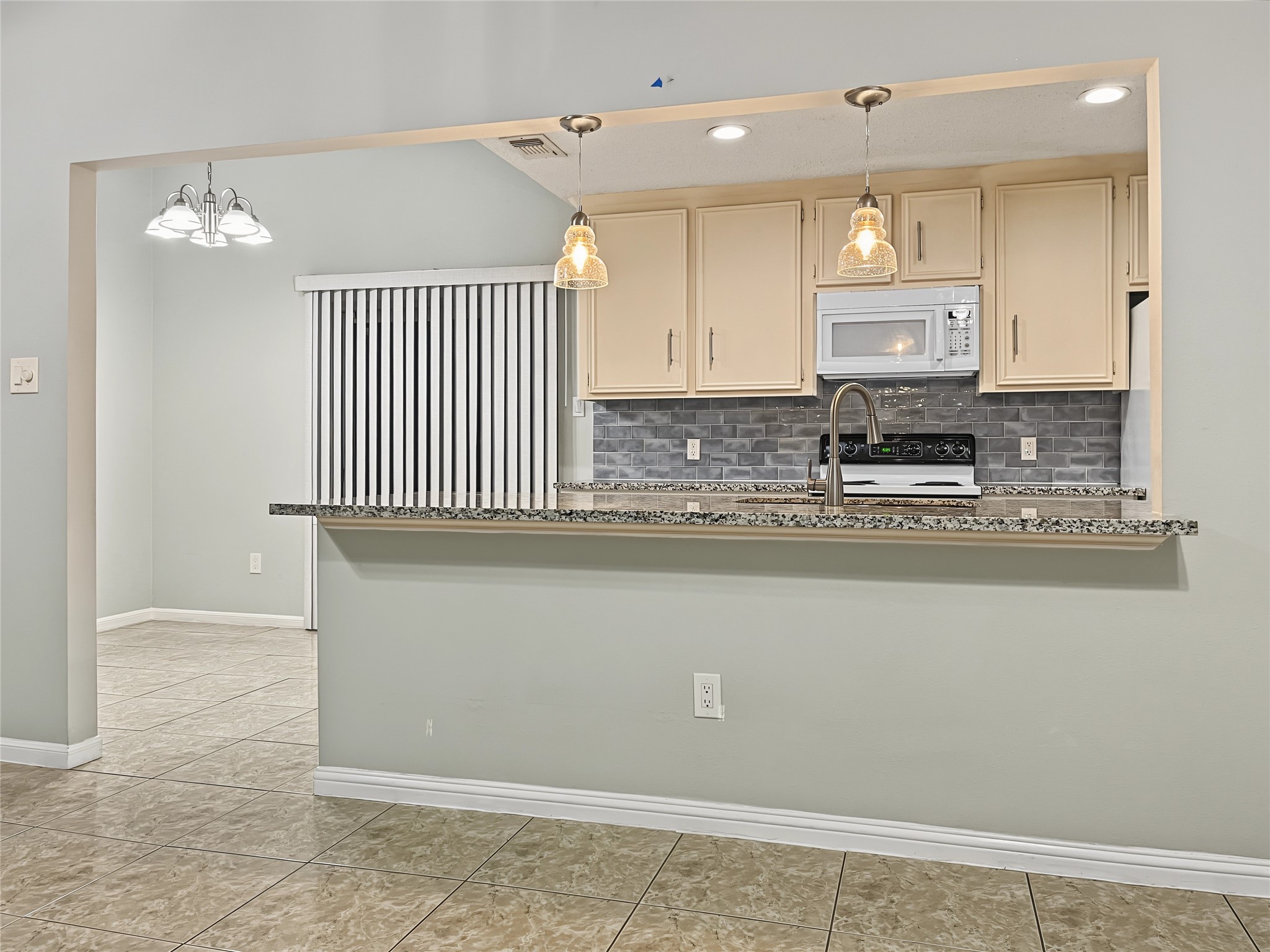 Great view of the open kitchen to the breakfast sunny nook and dining room area.