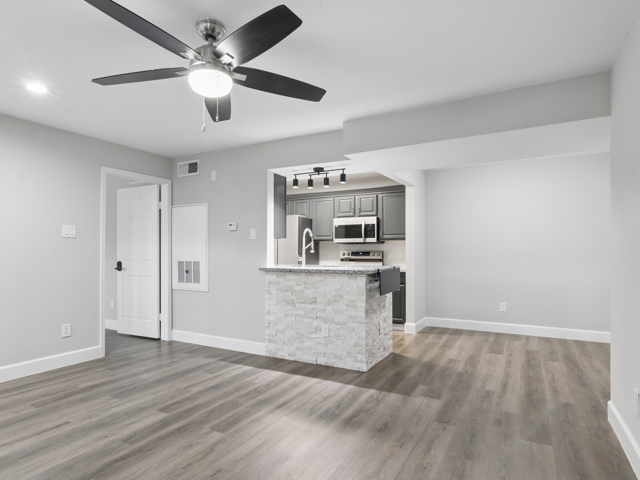 Living room open to kitchen with bar seating.