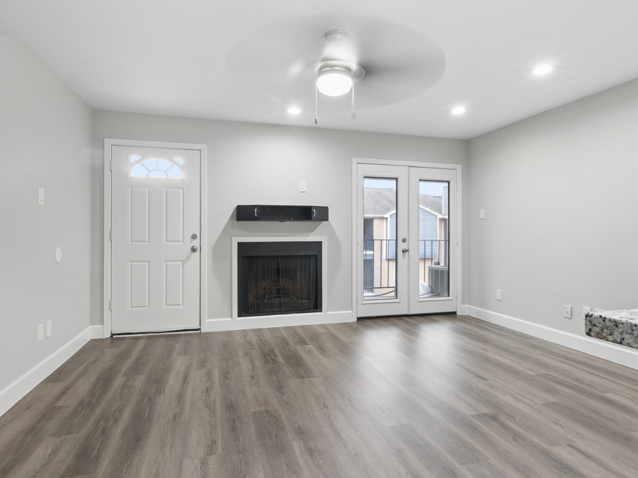 Living room with fireplace and balcony.