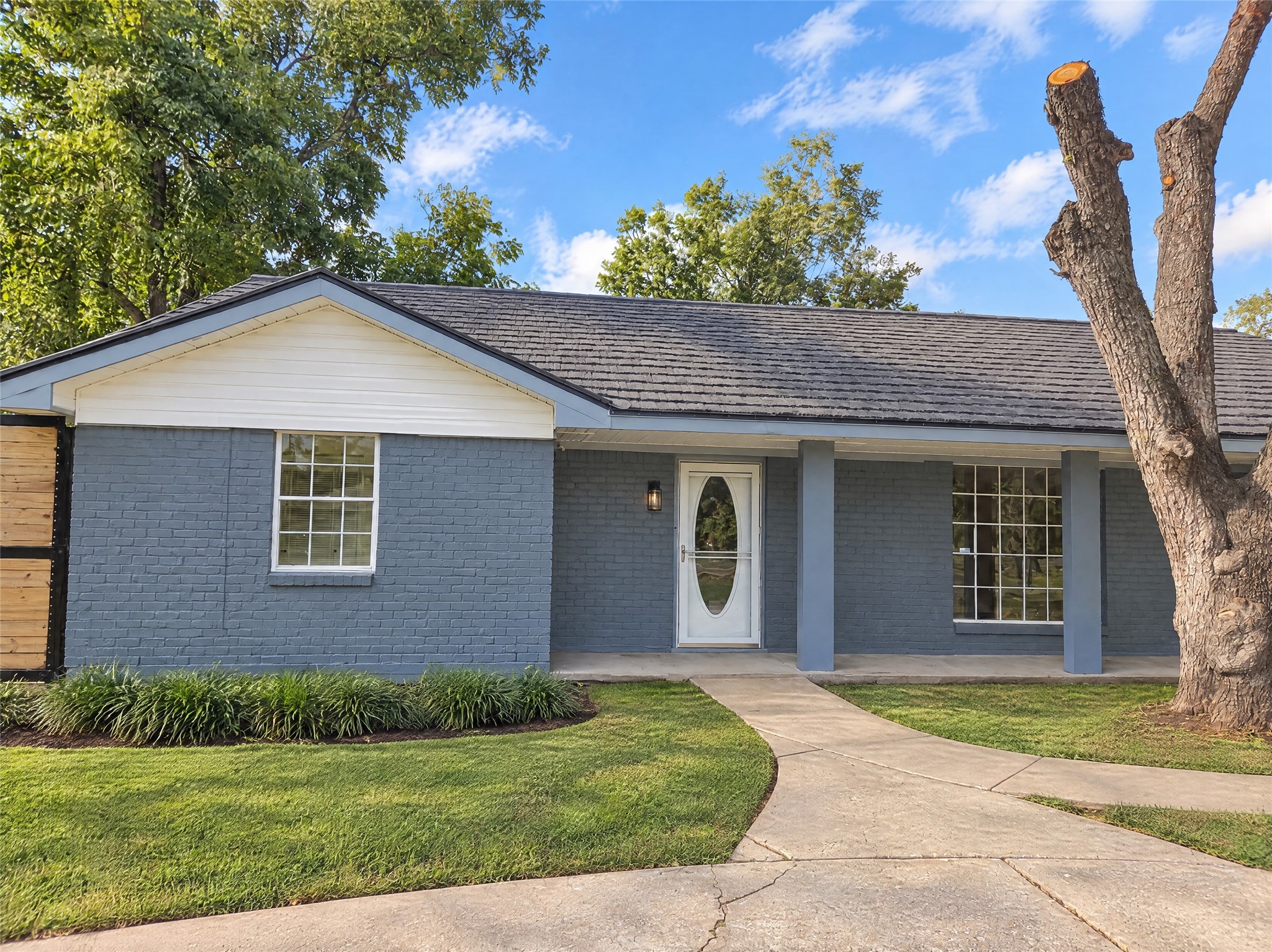 Welcome Home: Step up the curved walkway to this charming, beautifully updated single-story home. Featuring a fresh modern exterior palette, classic painted brick, crisp trim, and mature shade trees, this home greets you with undeniable curb appeal and a covered front porch perfect for morning coffee.