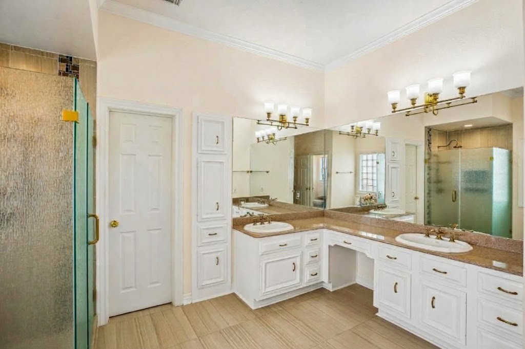 Frameless shower door for an oversized shower space. Walk-in closet with ample room for two.