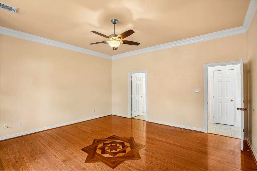 Primary room also features wood flooring and exquisite design detail.