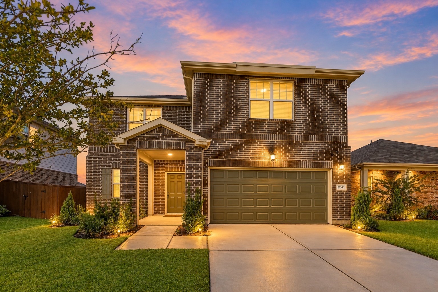 This stunning two-story brick home showcases exceptional curb appeal, beautifully highlighted by a vibrant twilight sky with soft pink, orange, and blue hues. The timeless brick exterior is complemented by an inviting covered front entry, a spacious two-car garage, and a wide concrete driveway. This stunning two-story brick home showcases exceptional curb appeal, beautifully highlighted by a vibrant twilight sky with soft pink, orange, and blue hues. The timeless brick exterior is complemented by an inviting covered front entry, a spacious two-car garage, and a wide concrete driveway.