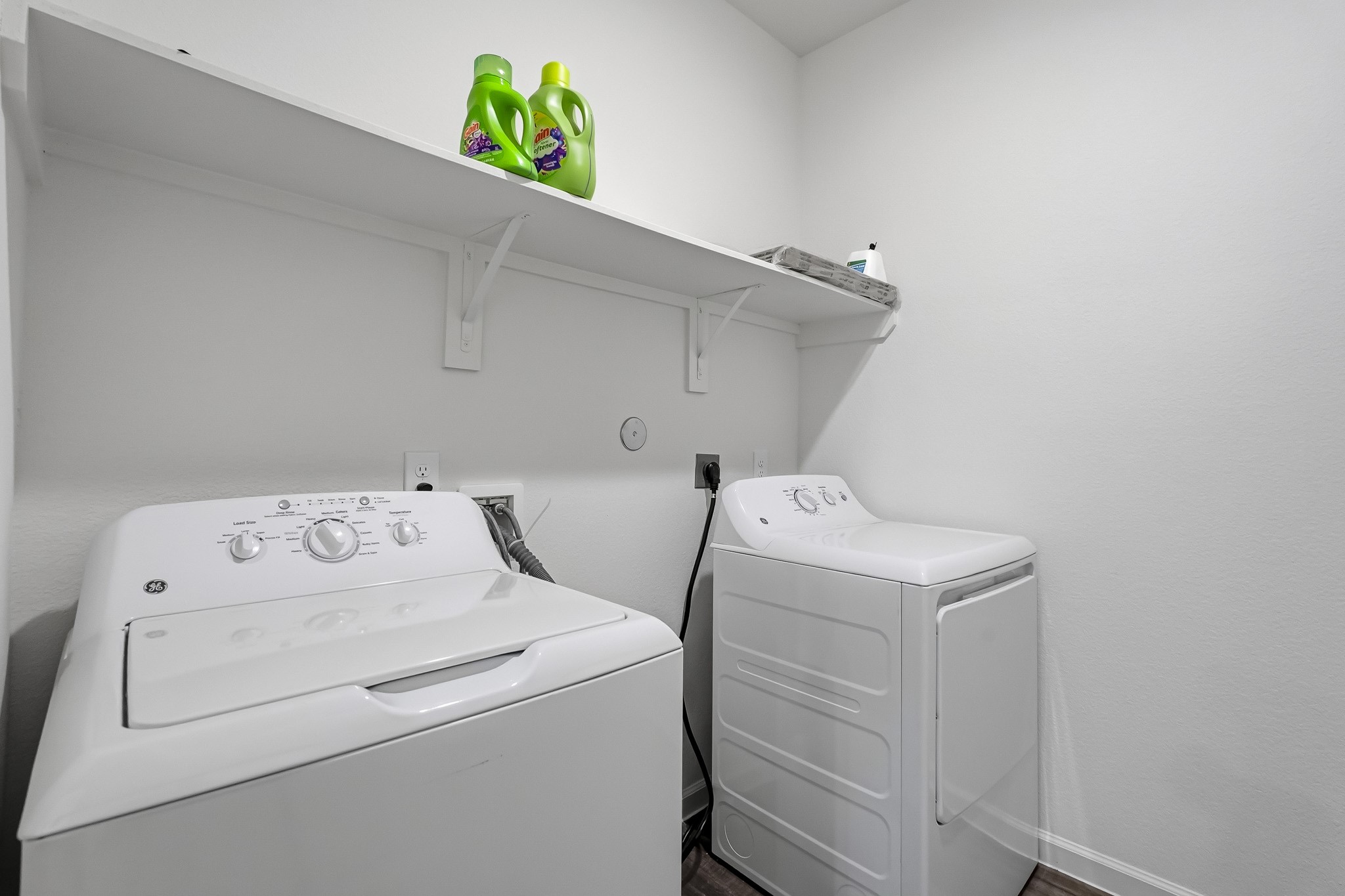 This dedicated laundry room features a clean, functional layout that maximizes the available space while providing an organized area for everyday household tasks.