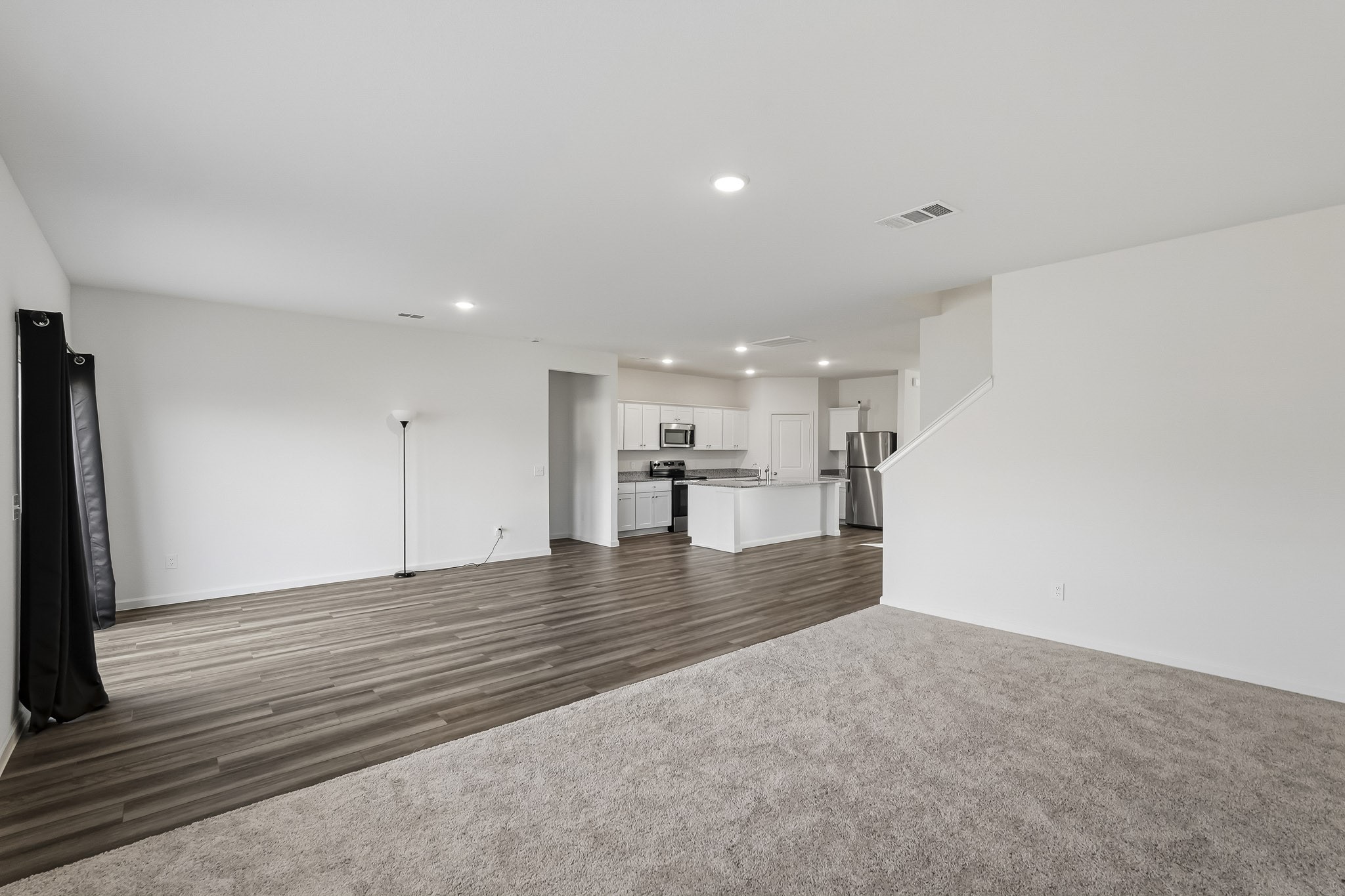 The spacious layout also features a distinct carpeted section, offering flexibility for an additional sitting area, entertainment space, or personalized living arrangement. With its generous proportions, versatile design, and inviting atmosphere, this space provides endless possibilities for relaxation and gatherings. The spacious layout also features a distinct carpeted section, offering flexibility for an additional sitting area, entertainment space, or personalized living arrangement. With its generous proportions, versatile design, and inviting atmosphere, this space provides endless possibilities for relaxation and gatherings.