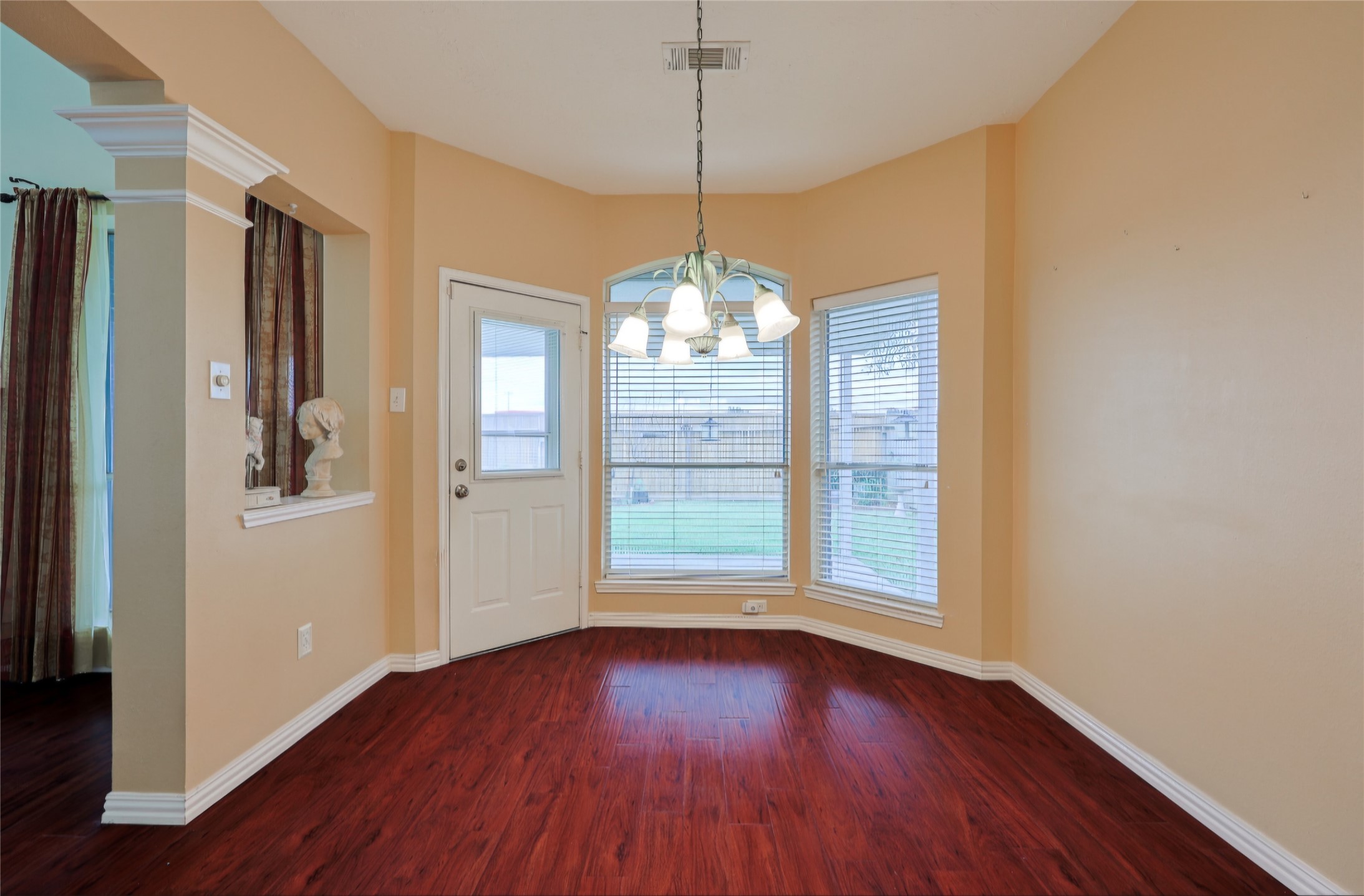 Breakfast rm with door accessing the back covered patio