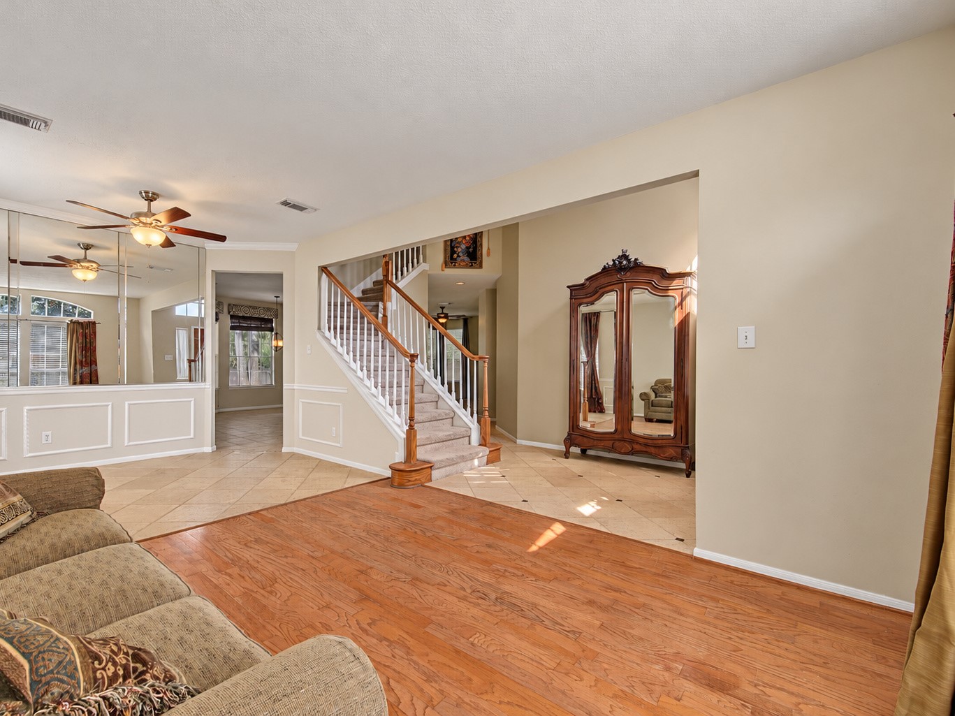 Formal living and dining rooms with wood flooring in the living room and travertine in the dining room Formal living and dining rooms with wood flooring in the living room and travertine in the dining room
