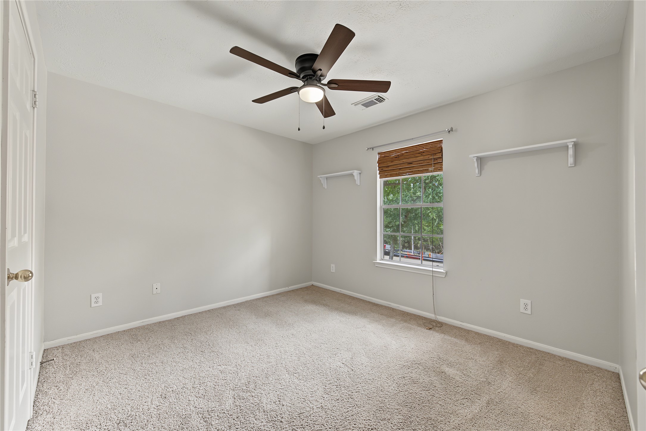 Secondary Bedroom 2 with a ceiling fan, natural light and wall-mounted shelves