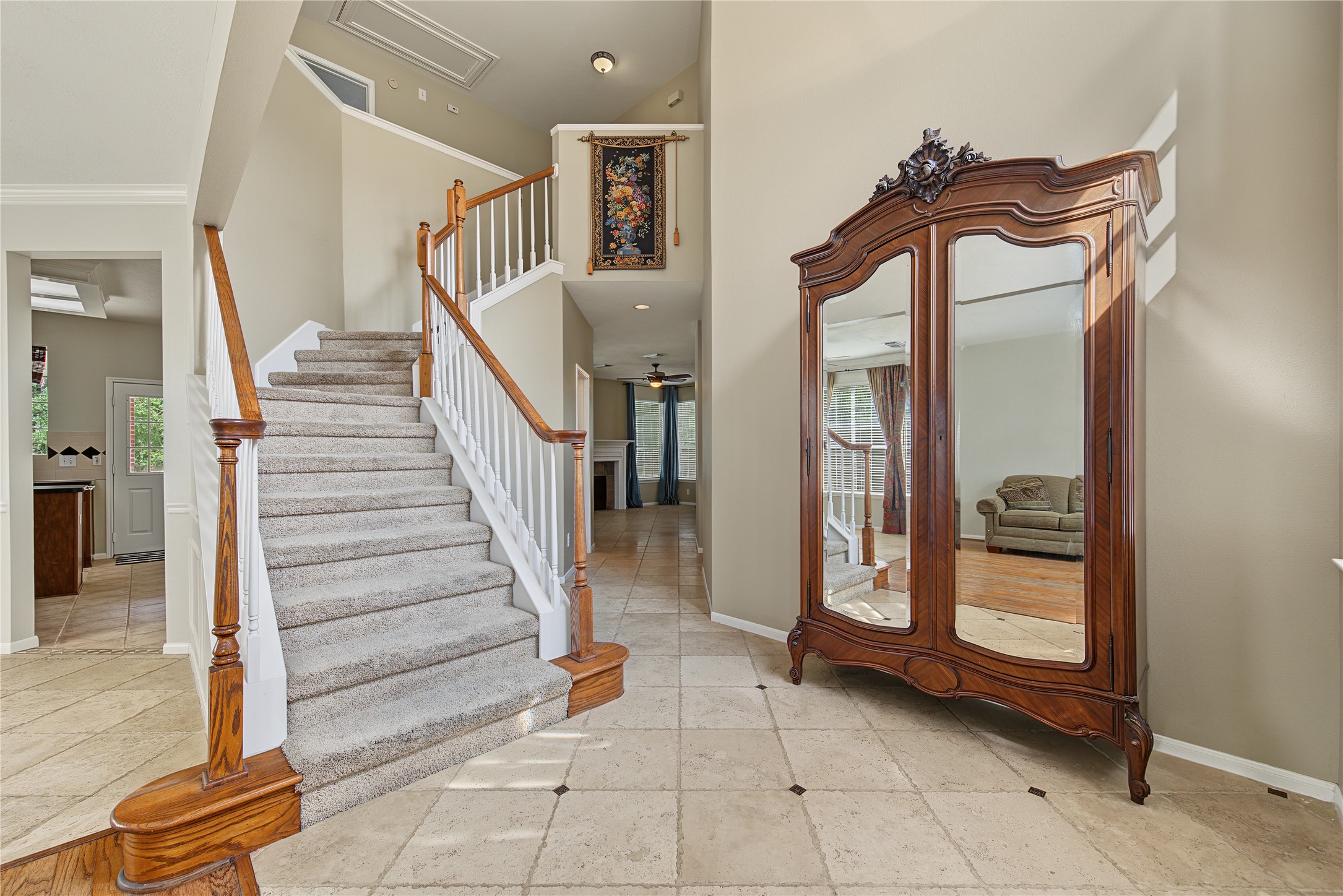 Welcoming foyer with soaring ceilings and an elegant curved staircase Welcoming foyer with soaring ceilings and an elegant curved staircase