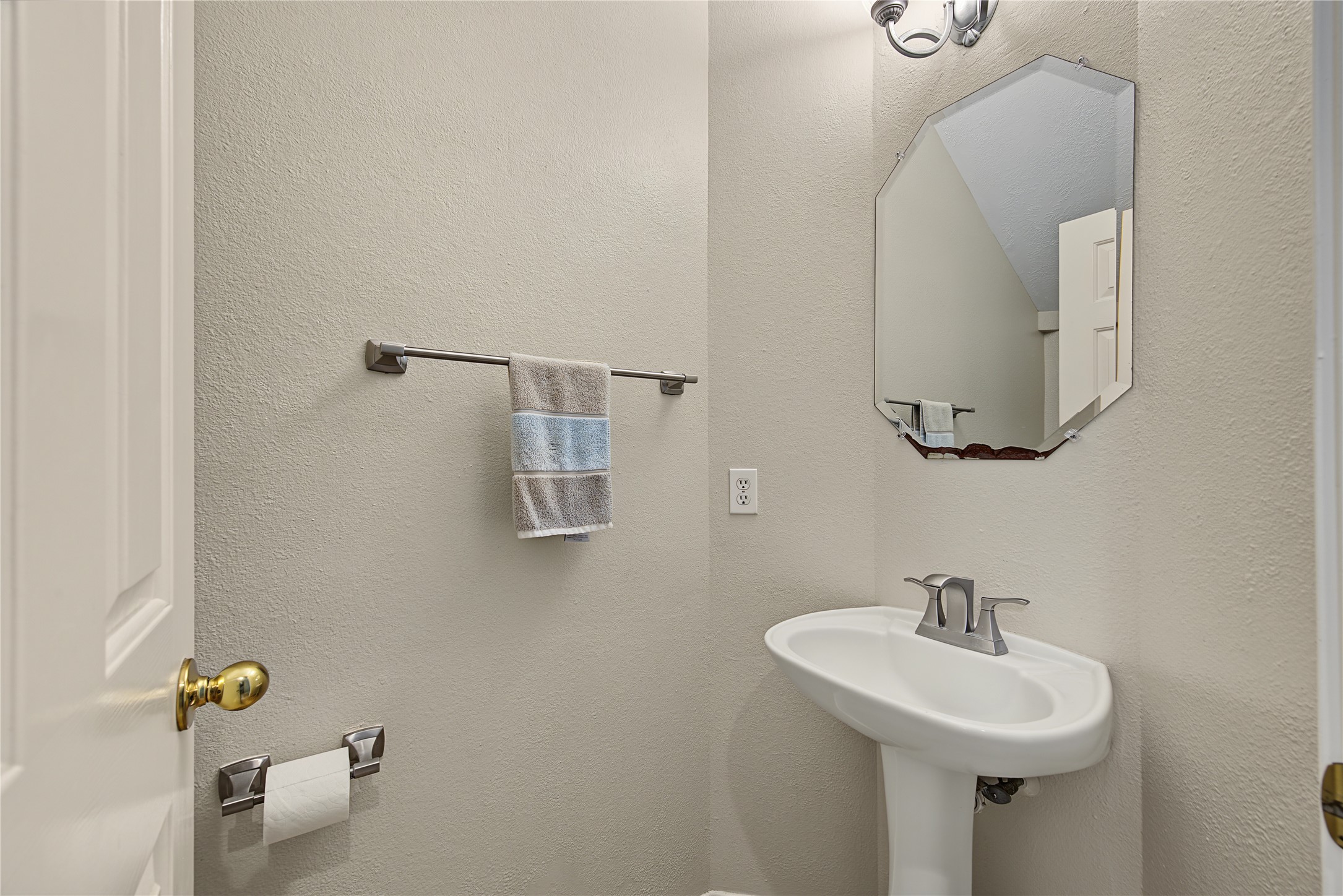 Convenient downstairs half bath with pedestal sink