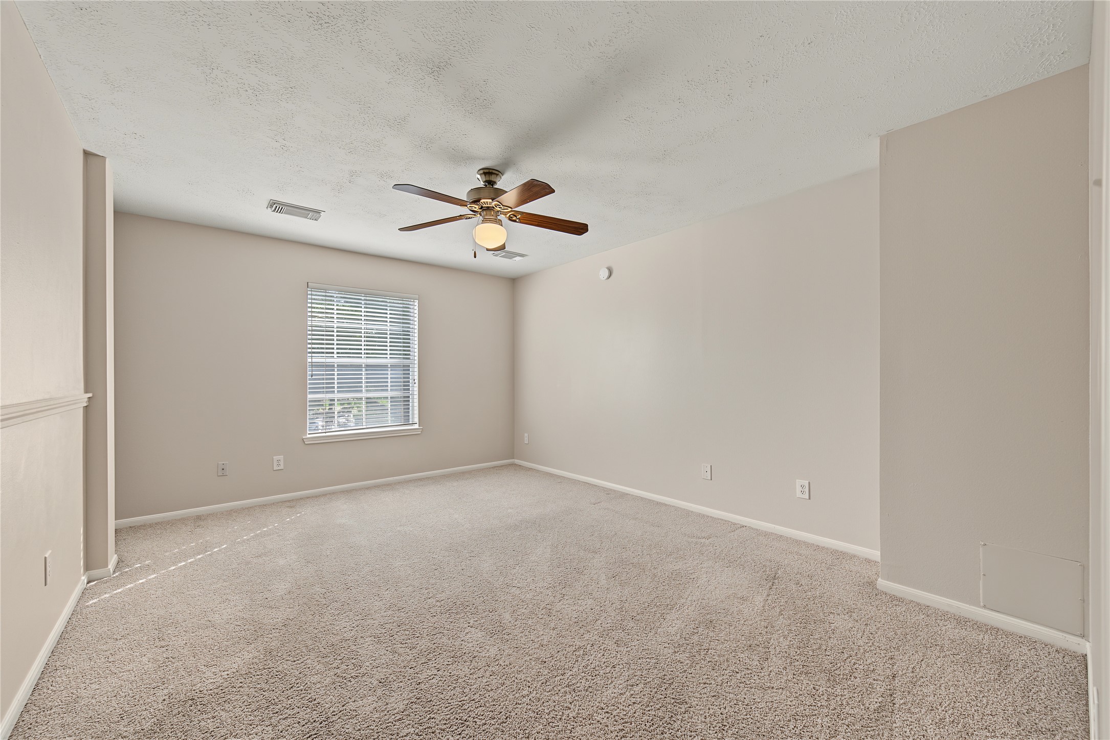 Generously sized Secondary Bedroom 3/flex space with a ceiling fan and window