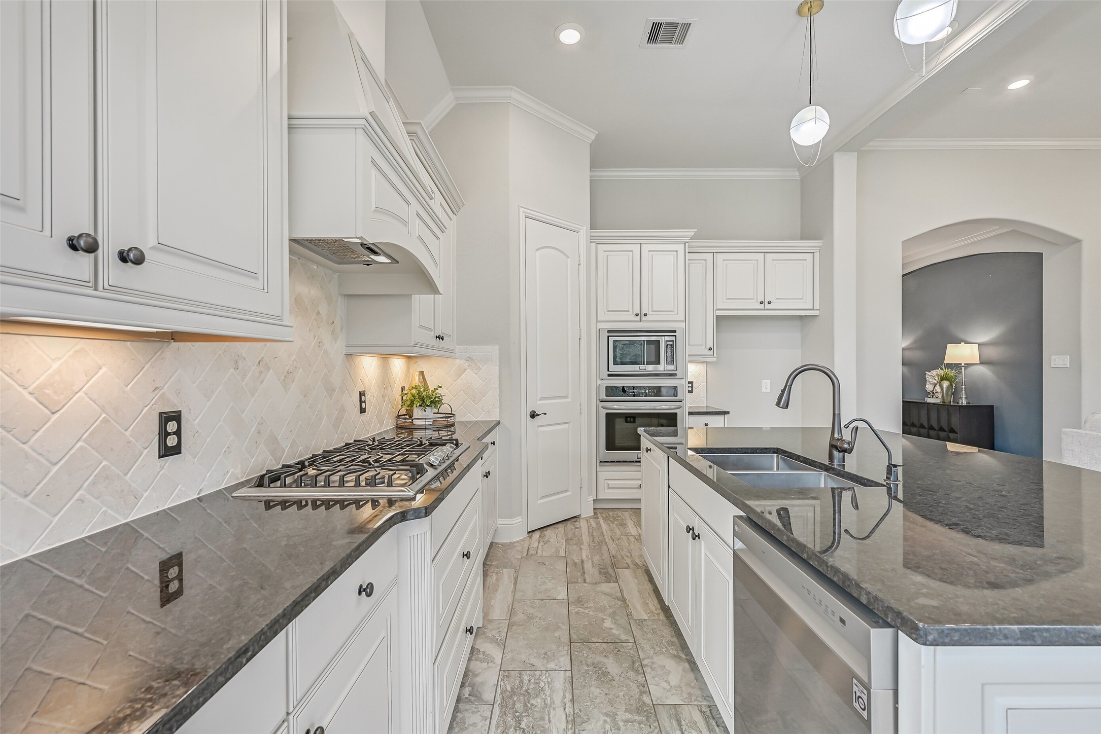 Another angle reveals the kitchen's generous workspace, abundant cabinetry & corner walk-in pantry. The oversized island provides a natural gathering spot, while the adjoining breakfast room enjoys windows overlooking the backyard.