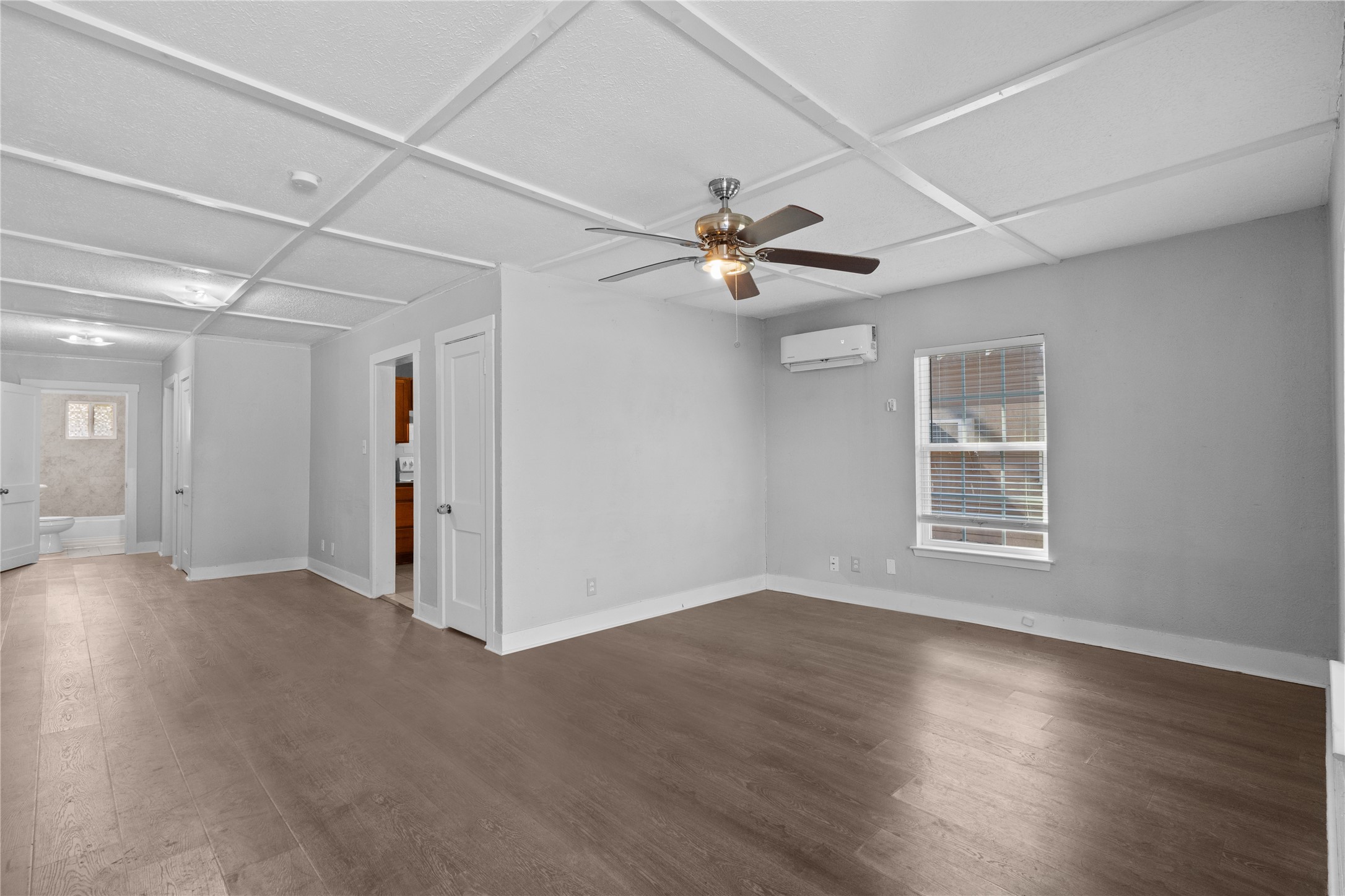 Main living area with peaceful, neutral paint, ceilings fan, and laminate wood flooing