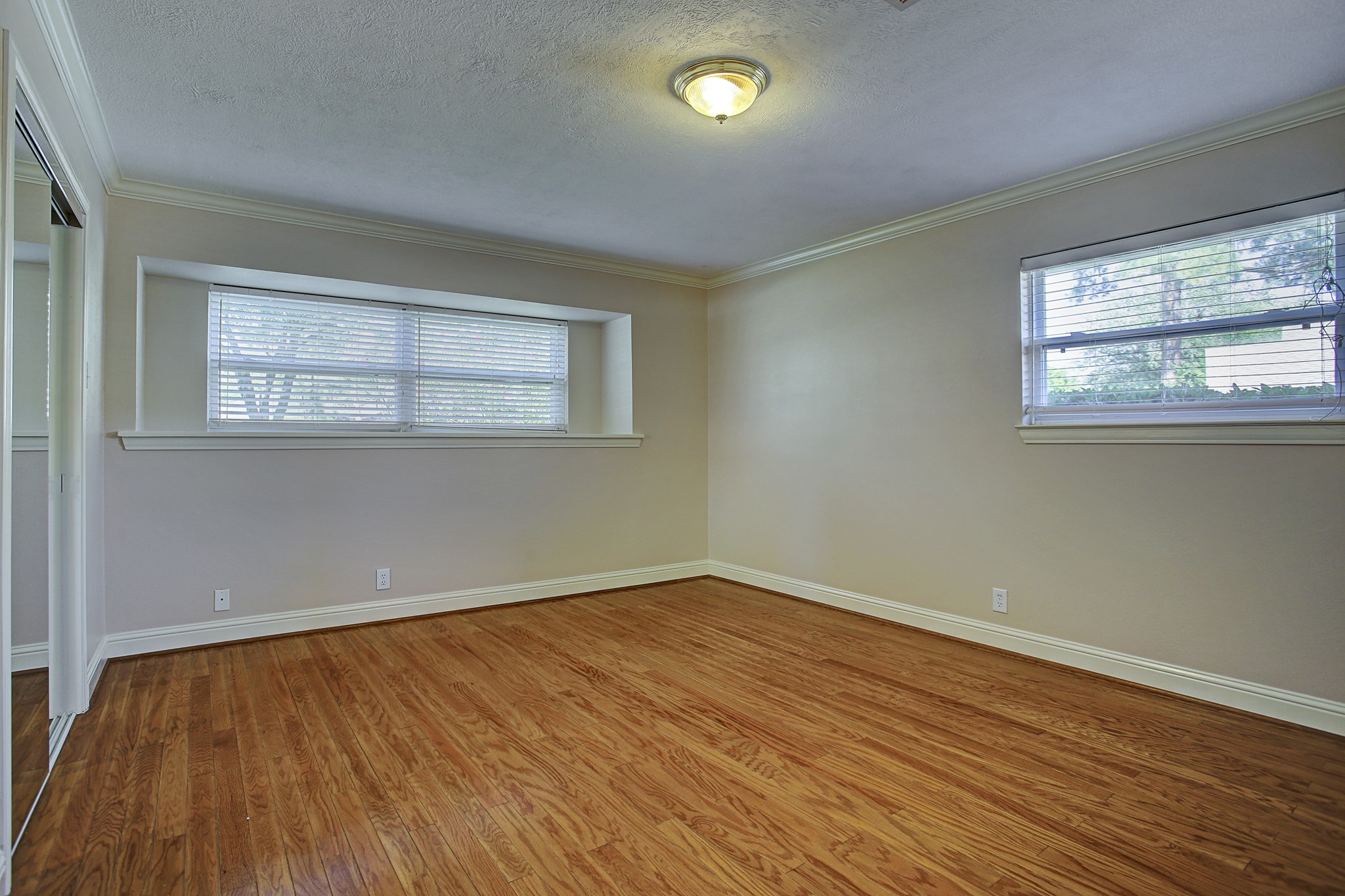 Windows on two walls bring the light; hardwood floors bring the warmth. Your furniture gets to do the rest.
