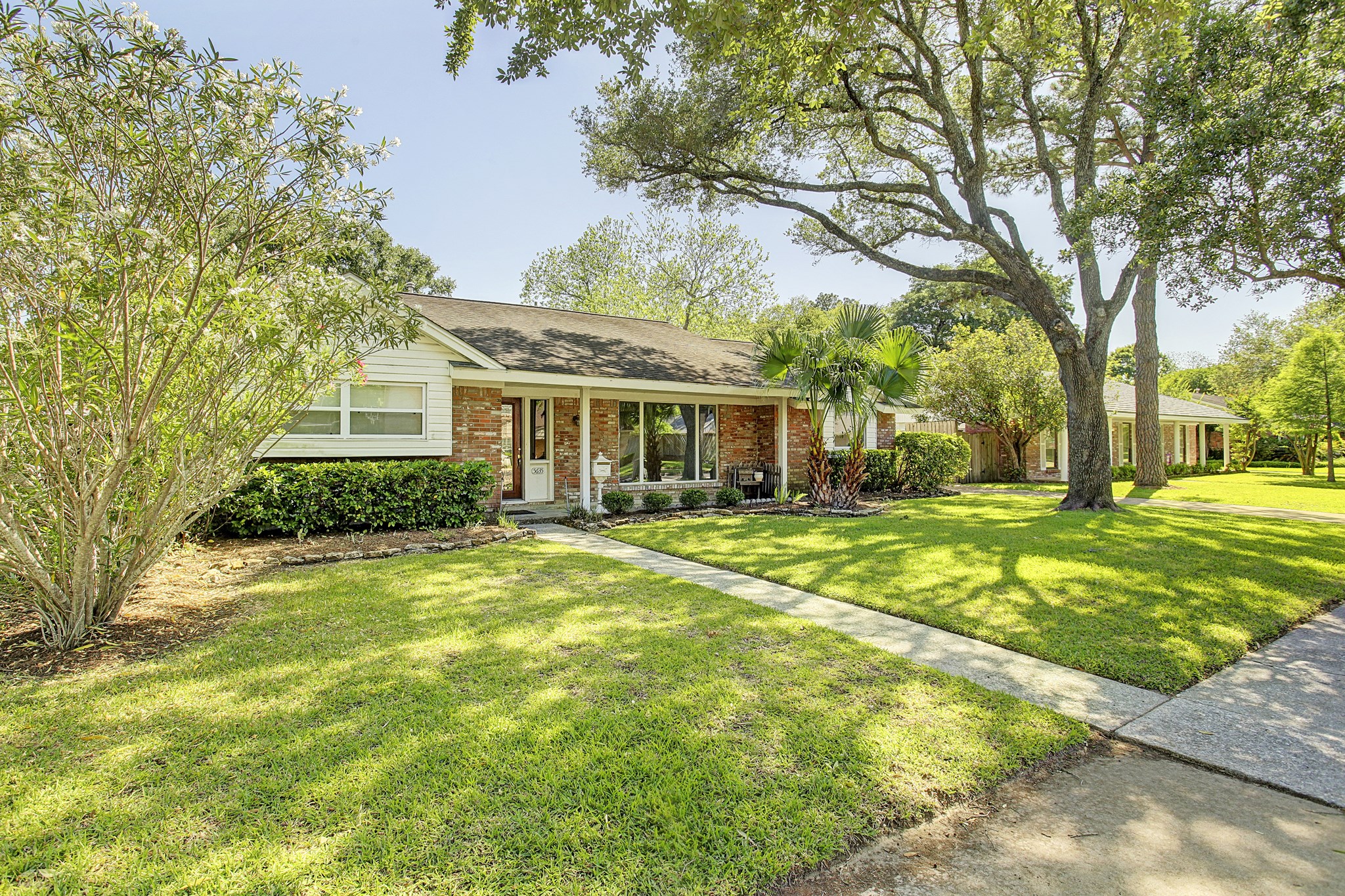 The kind of shade tree you cant order online. Established landscaping gives this front yard its character. The kind of shade tree you cant order online. Established landscaping gives this front yard its character.