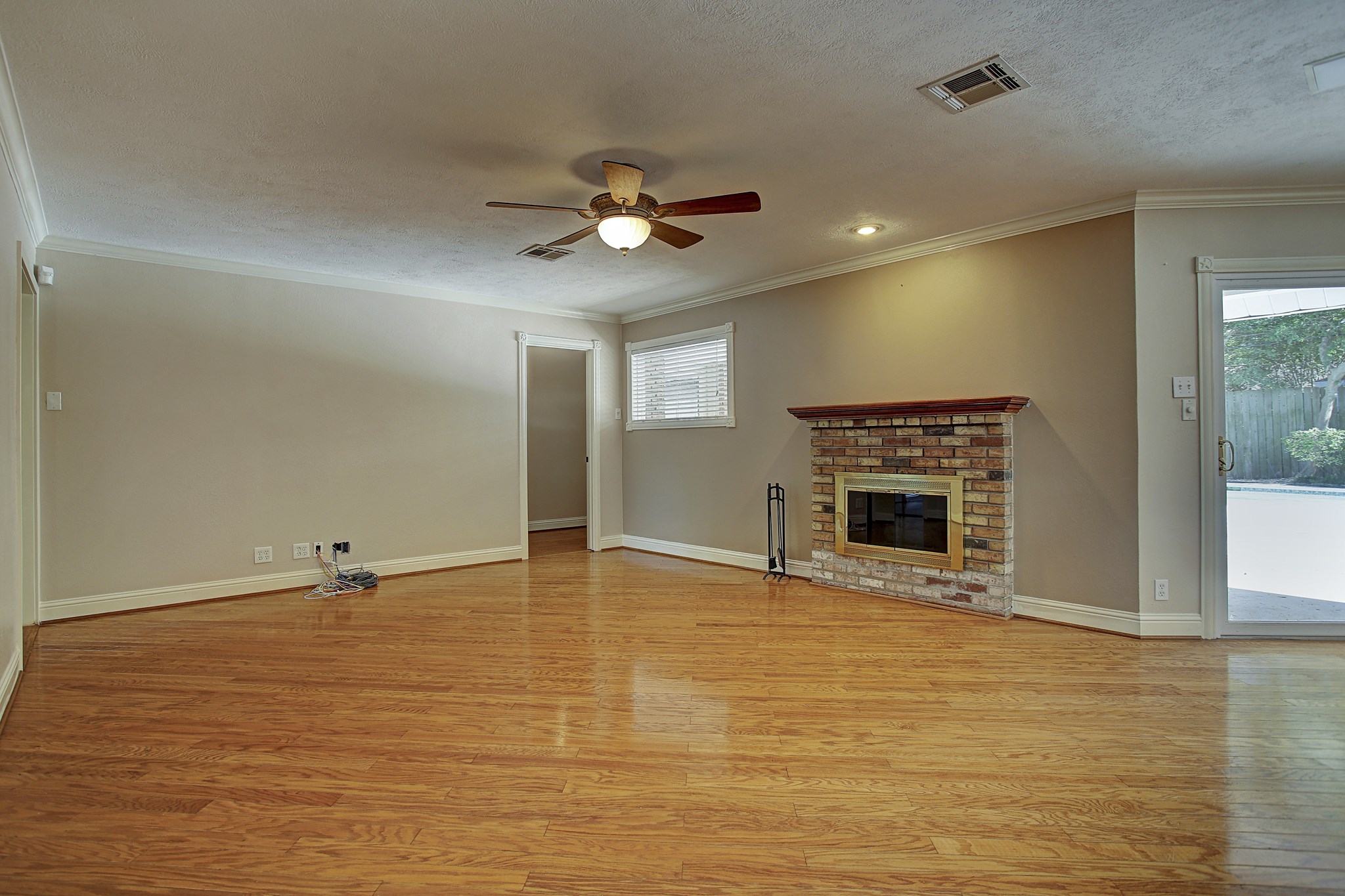 Fireplace weather or pool weather? With the patio just outside, this living room is ready for either.