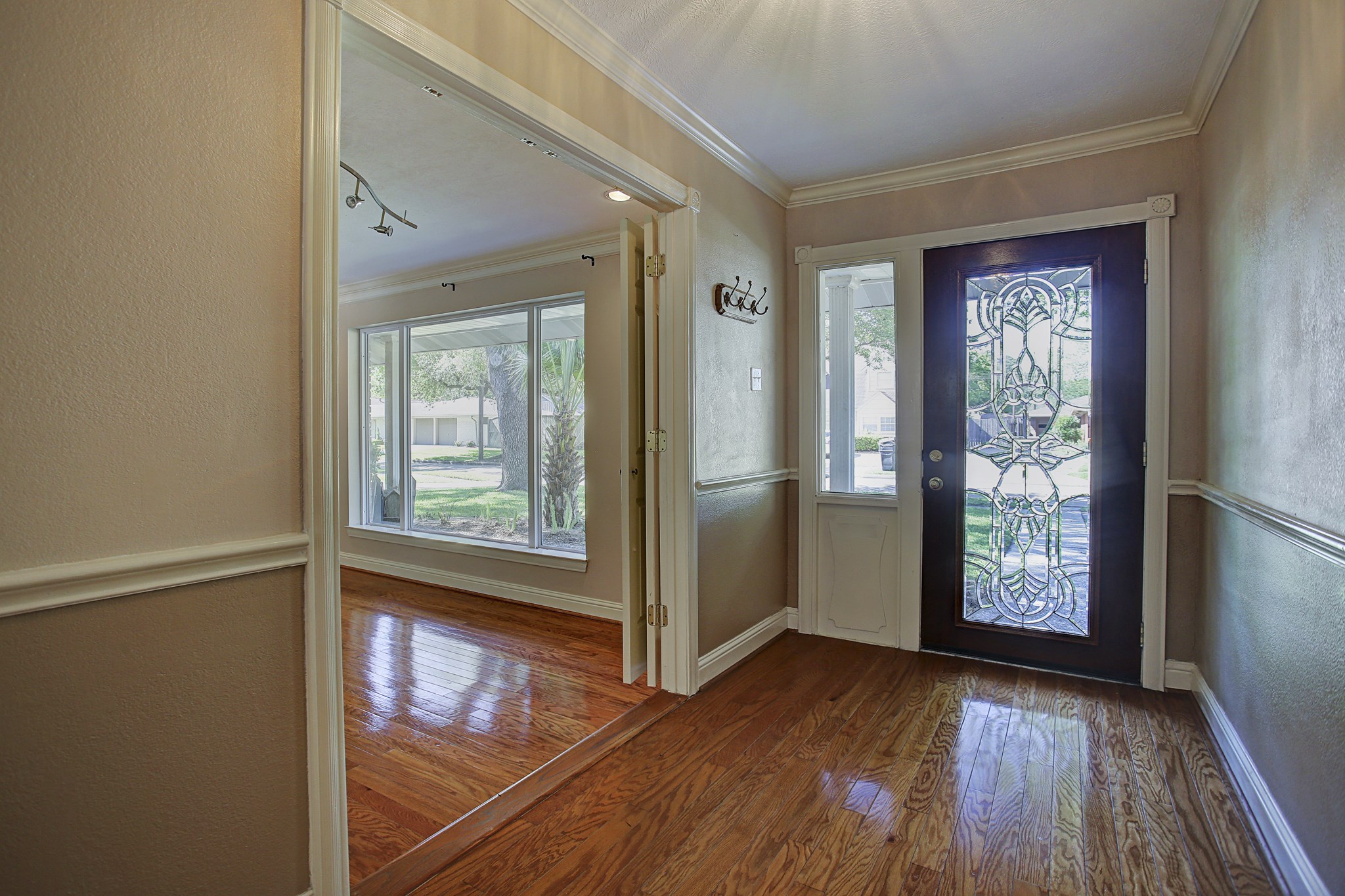 Hardwood floors, a decorative glass door, and a glimpse of the light-filled front living room make a warm first impression. Hardwood floors, a decorative glass door, and a glimpse of the light-filled front living room make a warm first impression.