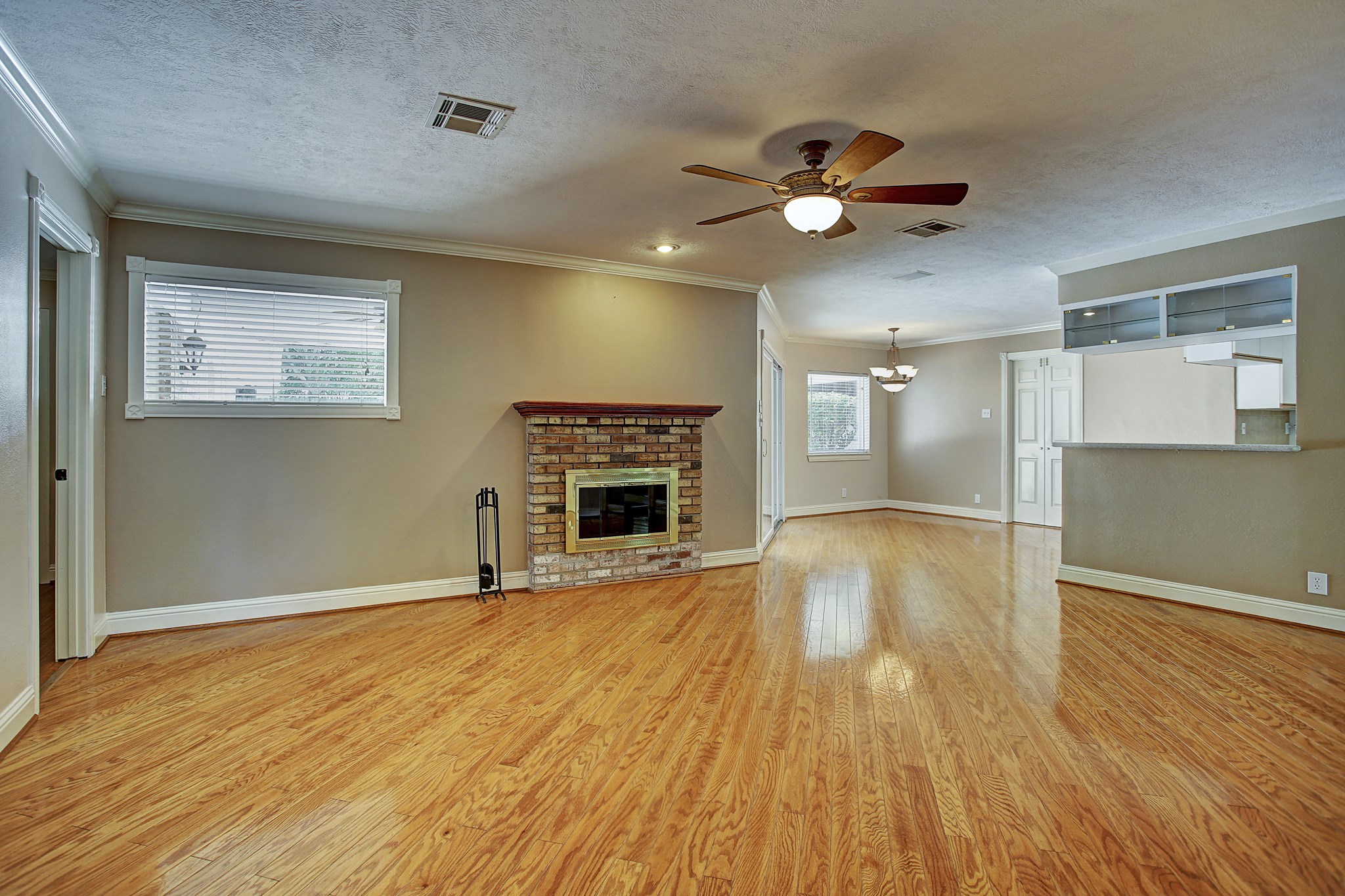 Get the big sectional. This generous living room has the space for it, with hardwood floors and a brick fireplace to pull it all together.