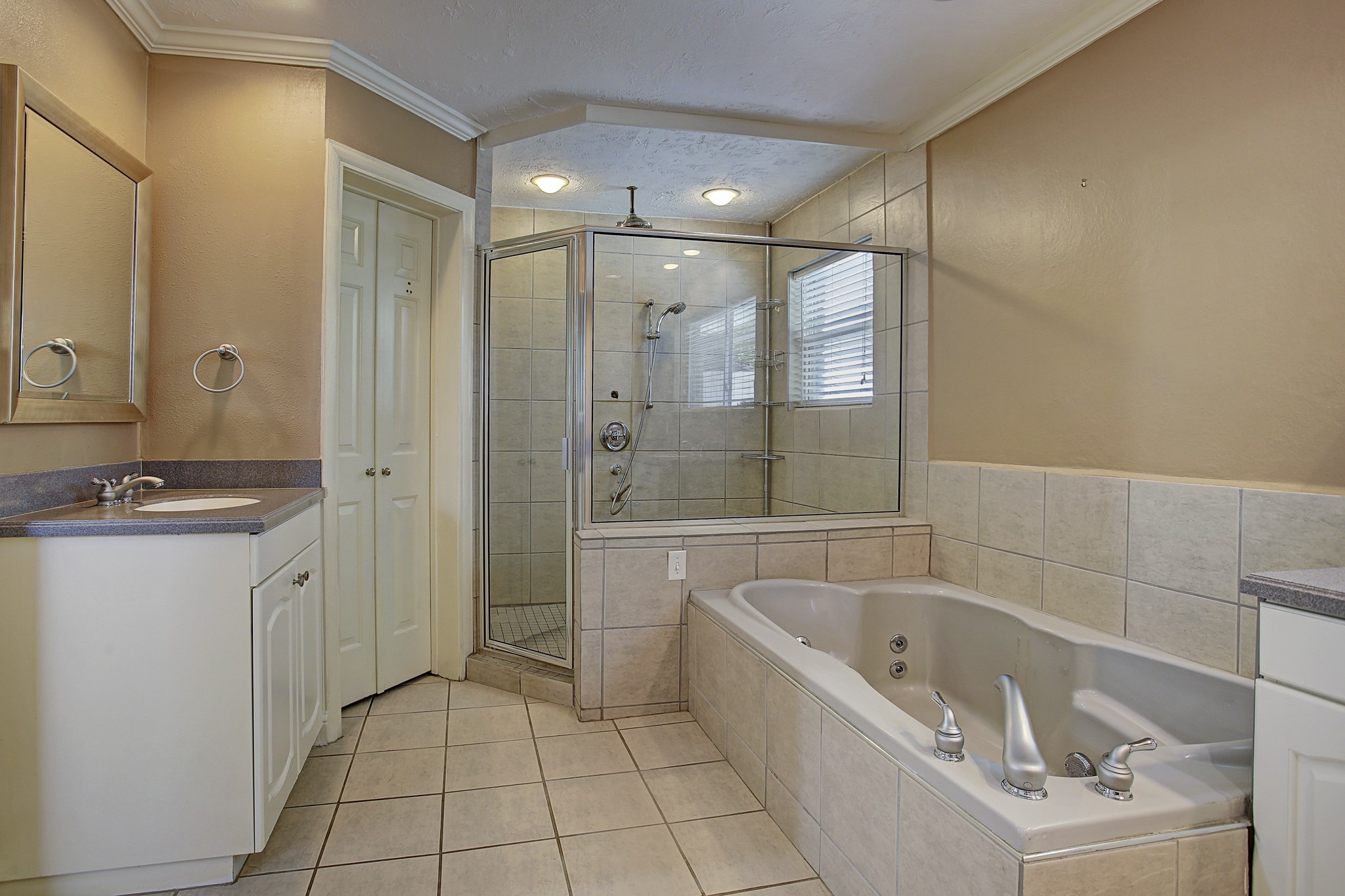 Separate sinks, a soaking tub, and a glass-enclosed shower mean you can claim your counter space and keep it.