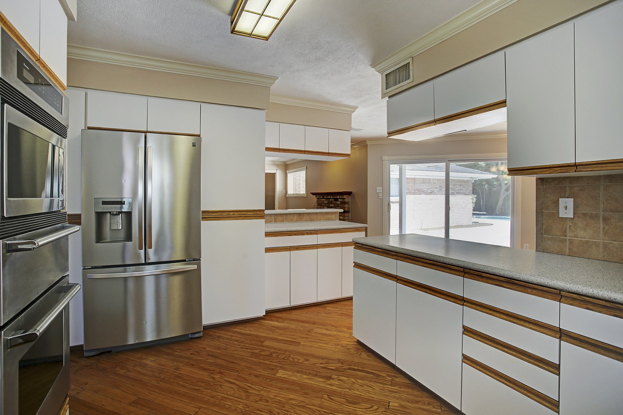 A kitchen pass-through keeps the conversation going while you cook, with a backyard view to keep an eye on the pool plans.