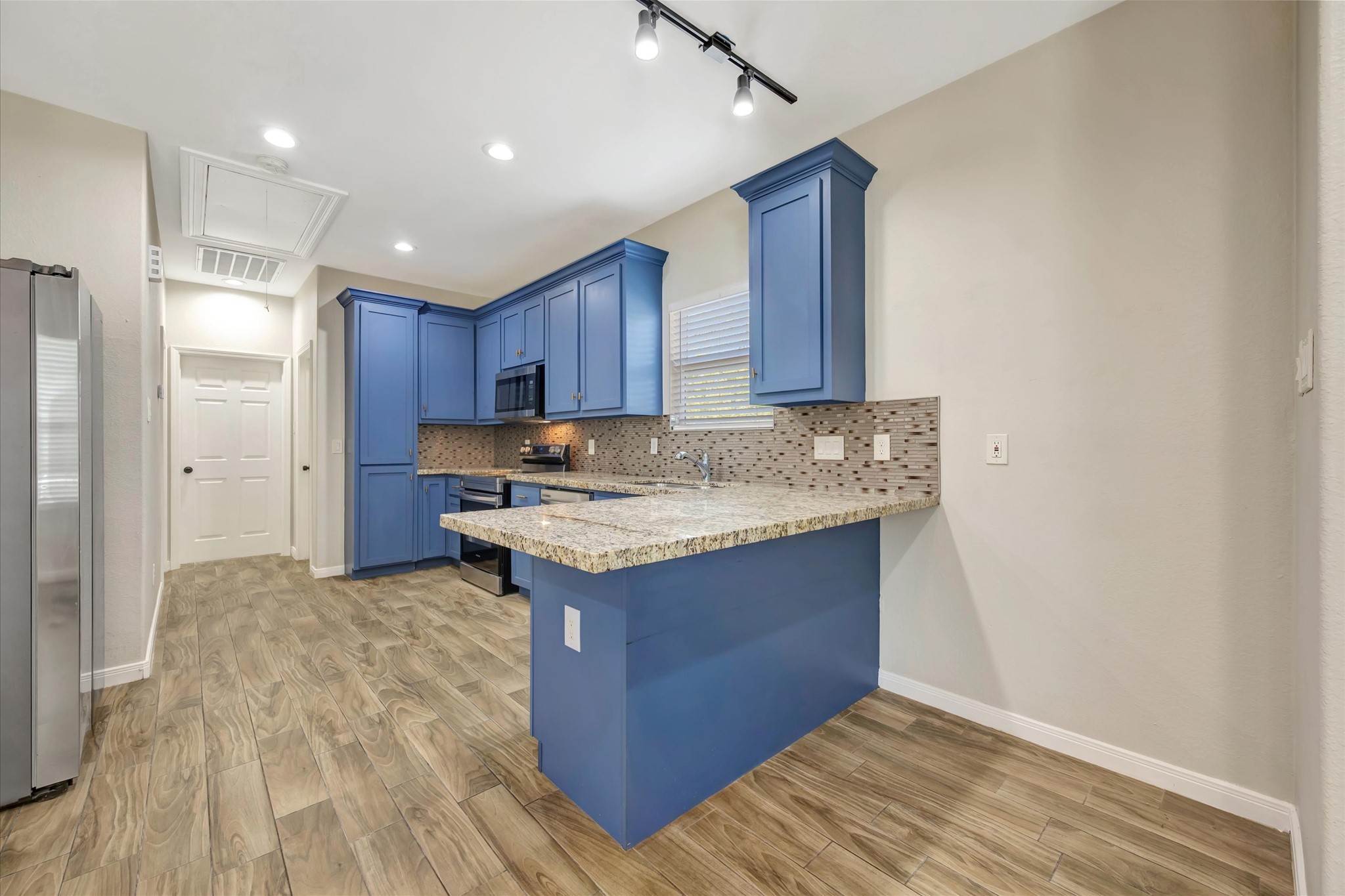 Kitchen with custom built cabinets and bar area