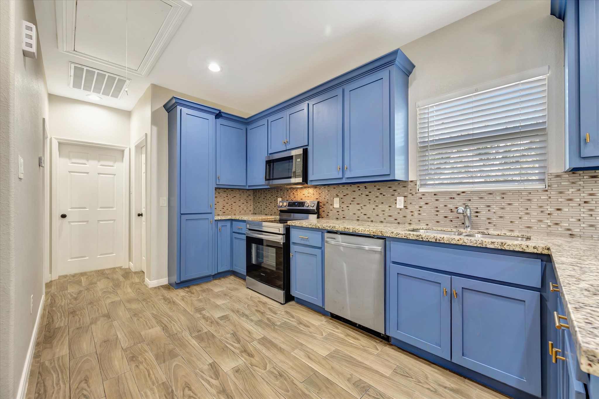 Kitchen with Stainless Steel Applicances (microwave is new); Granite Countertops and brass colored hardware