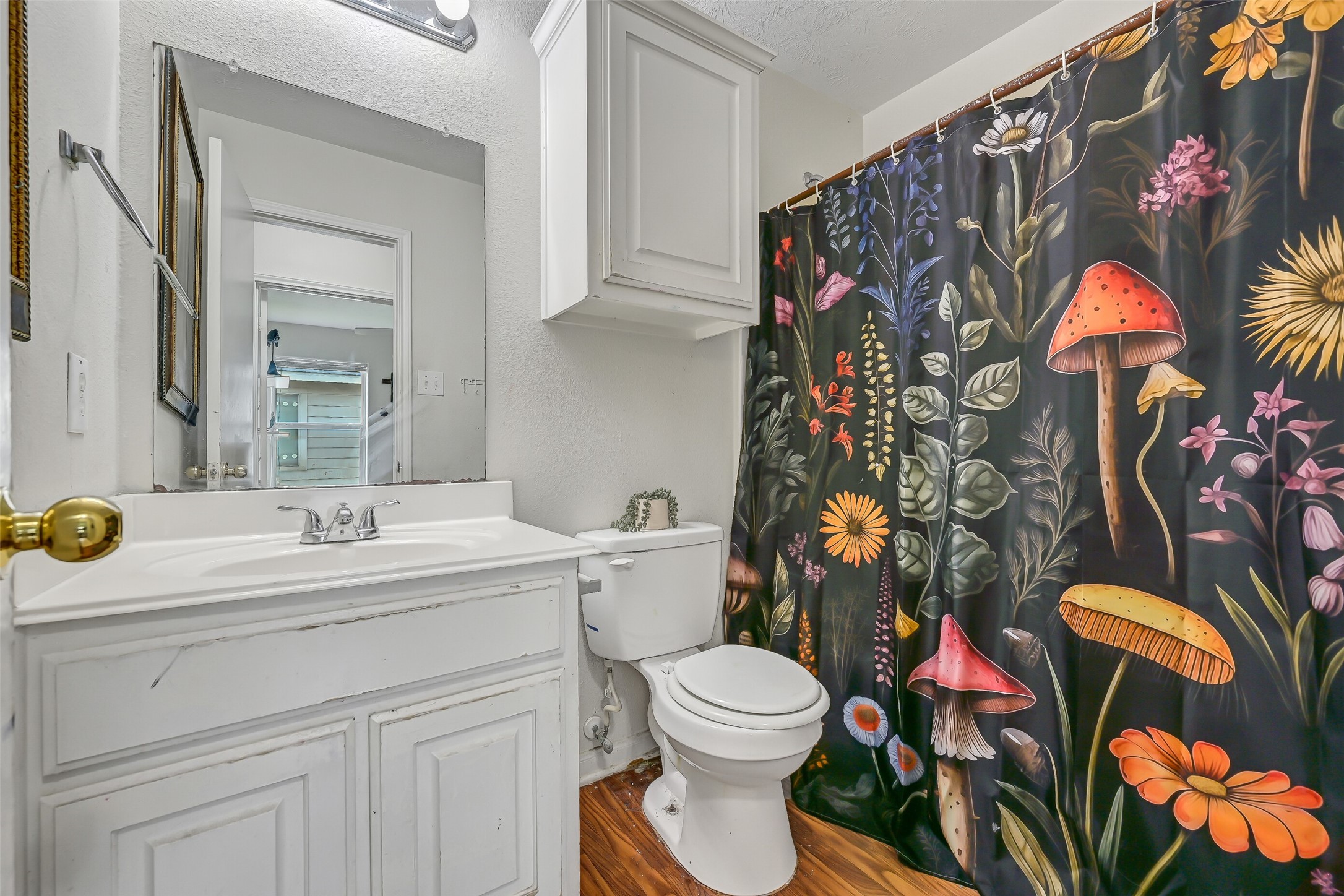 The second full bath includes a vanity with storage, large wall mirror, tub/shower combination, and additional upper cabinetry.