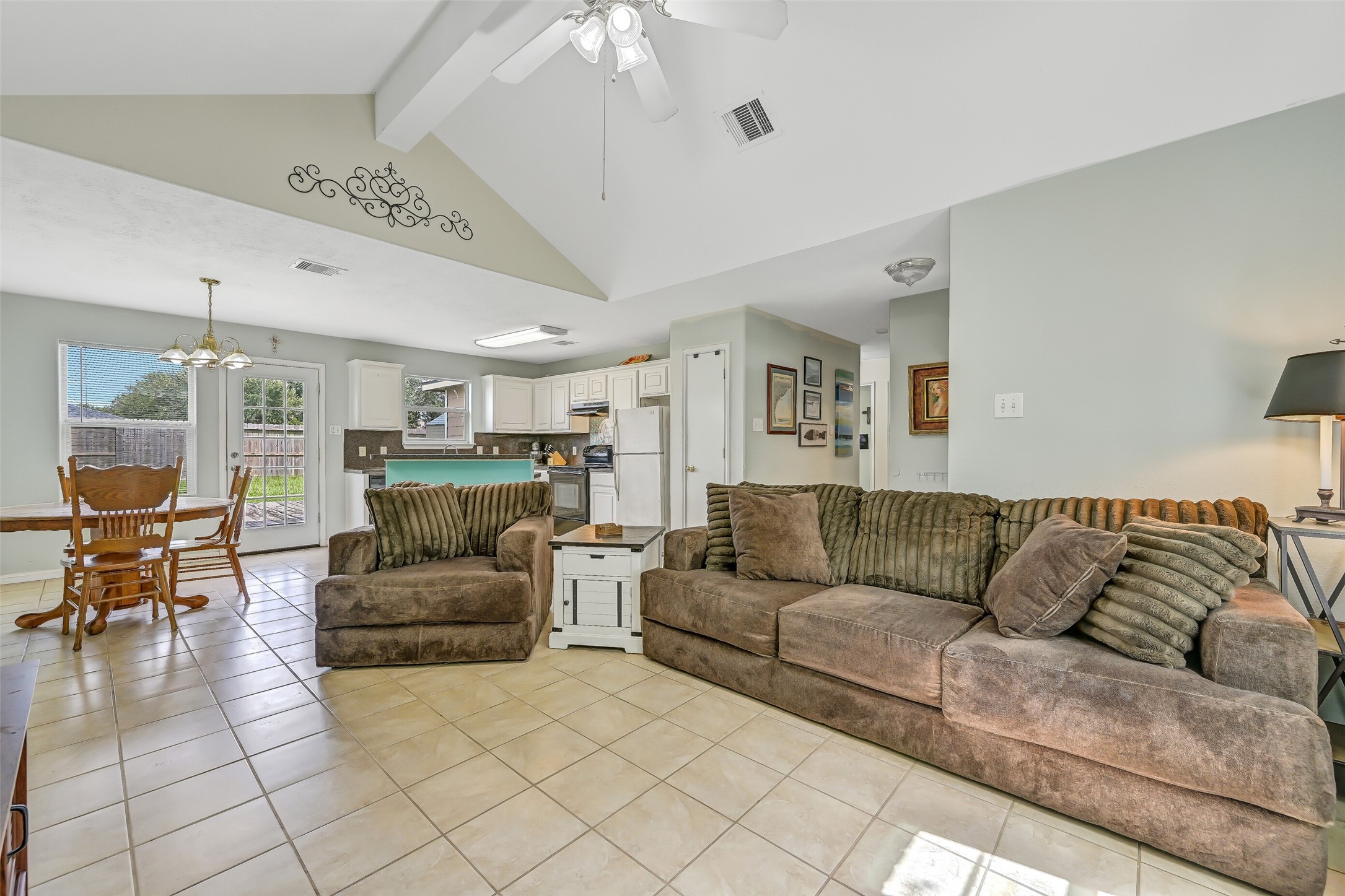 A wide-angle view shows just how well the home's main living spaces connect, with the family room opening directly to the dining area and kitchen beyond.