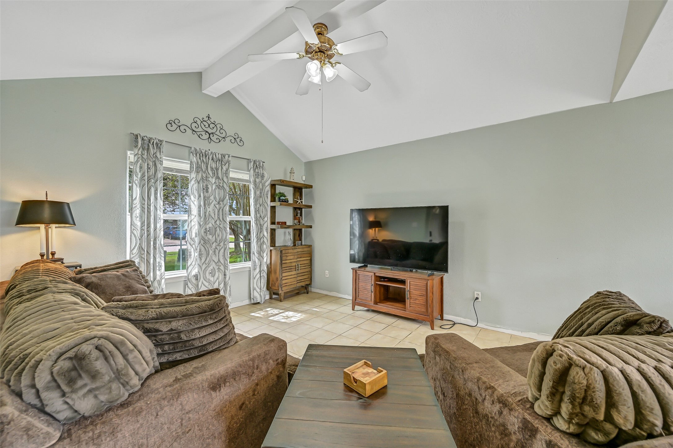 Another view of the family room showcases its vaulted ceiling and generous wall space, offering plenty of flexibility for furniture and entertainment placement.
