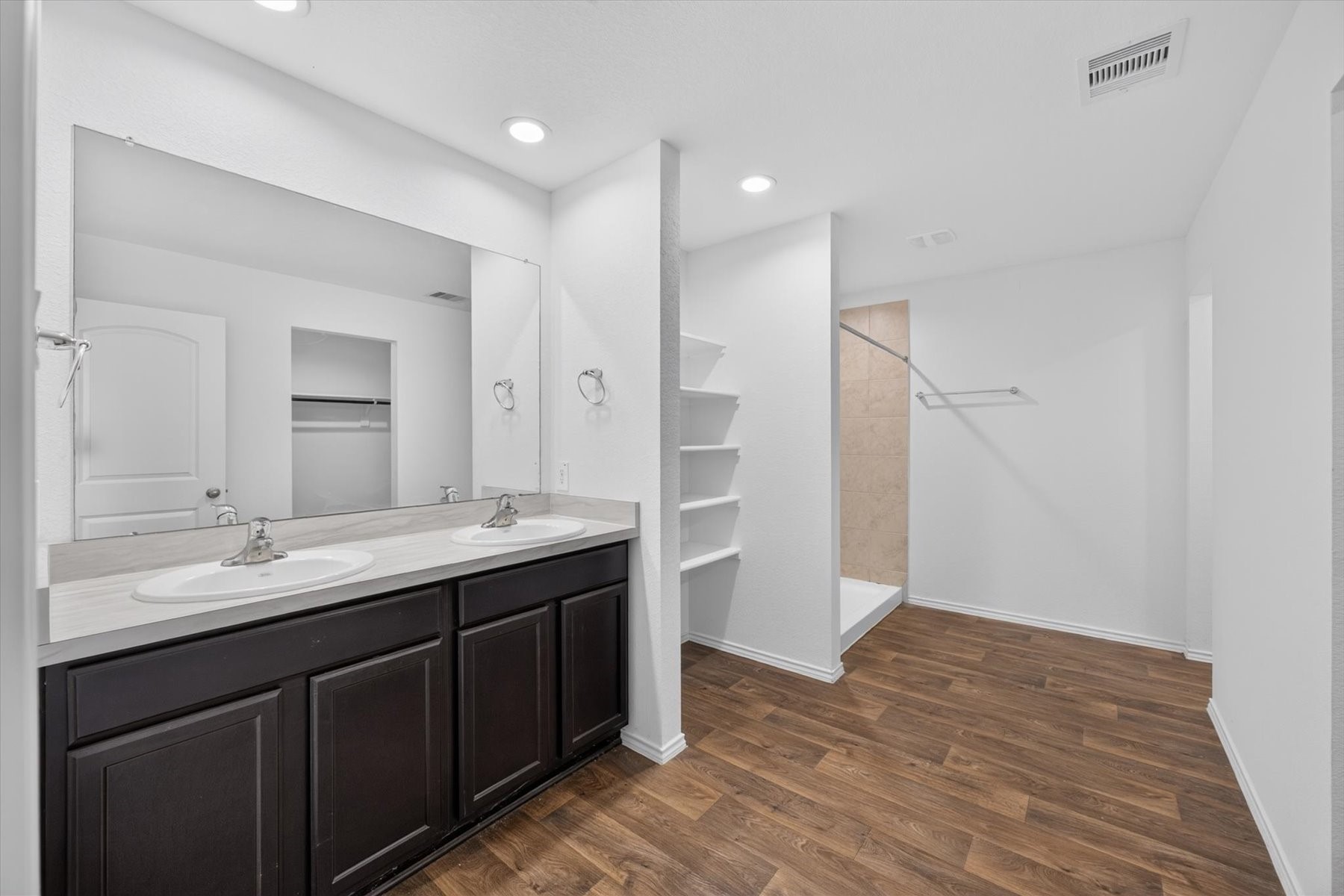 Primary bath with dual sinks and ample storage.