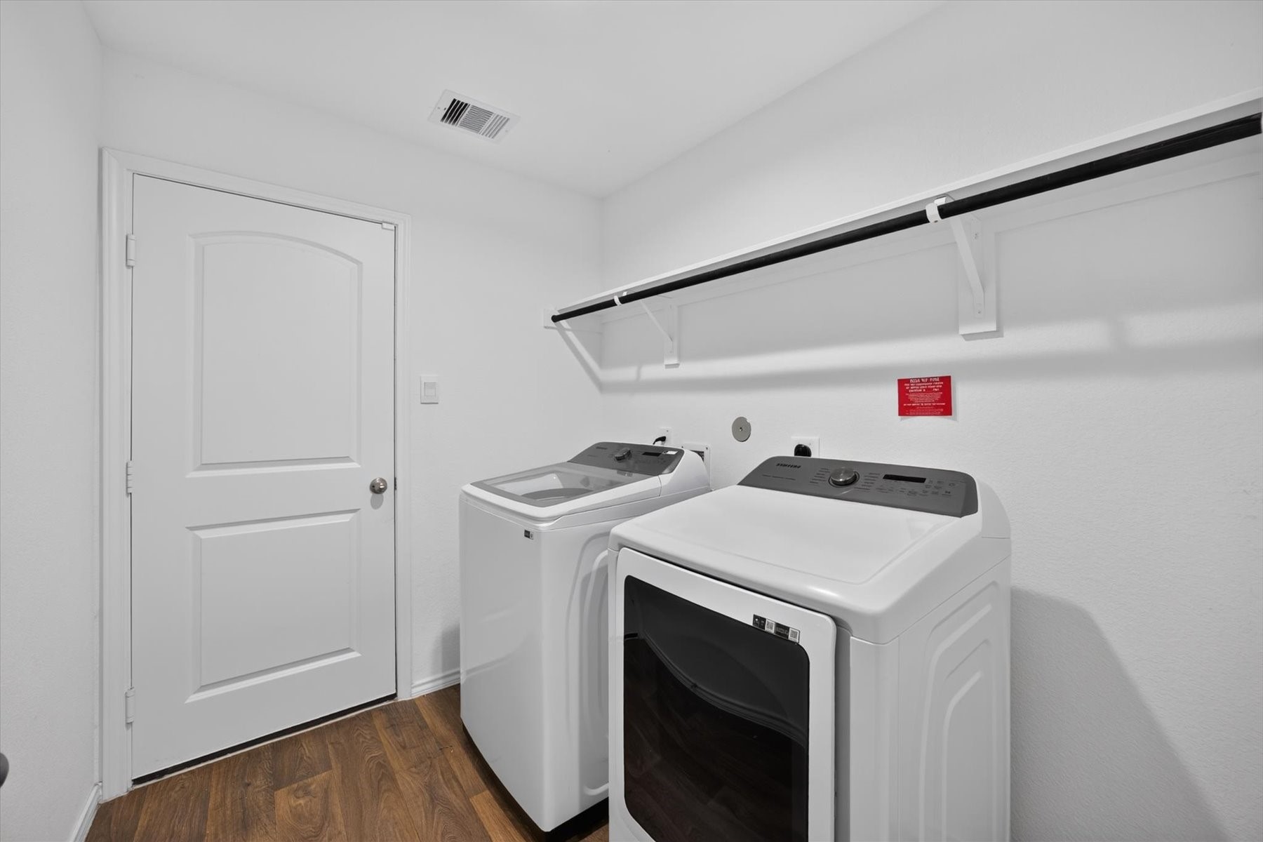 Convenient laundry room with built-in shelving.