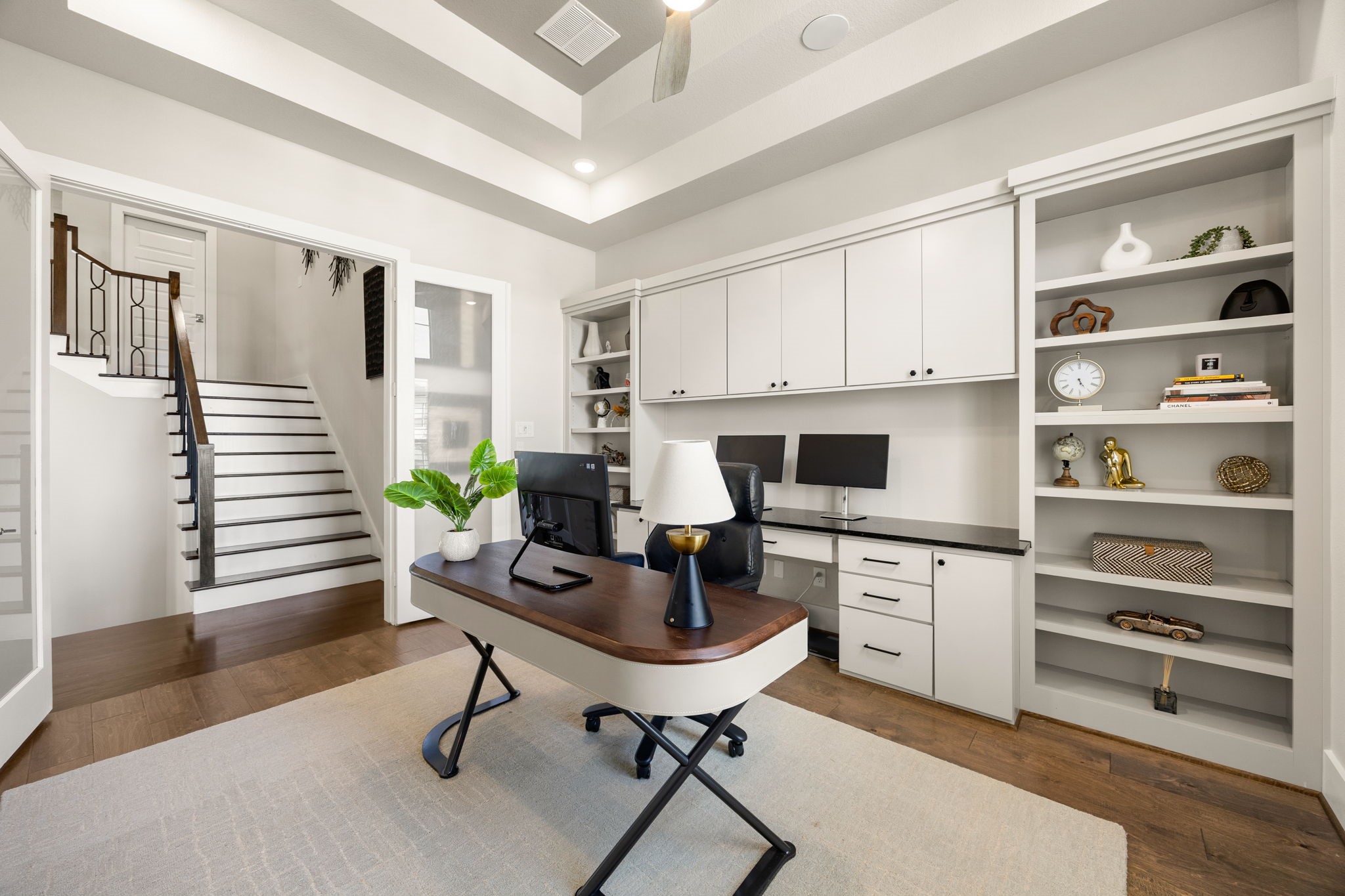 Elegant study showcasing custom built-ins, beautiful ceiling details, and a functional workspace.