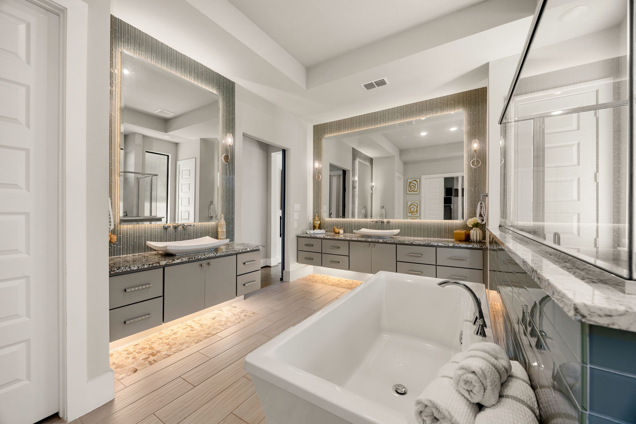 Beautiful primary bathroom with a relaxing soaking tub, generous vanity space, and sophisticated finishes.