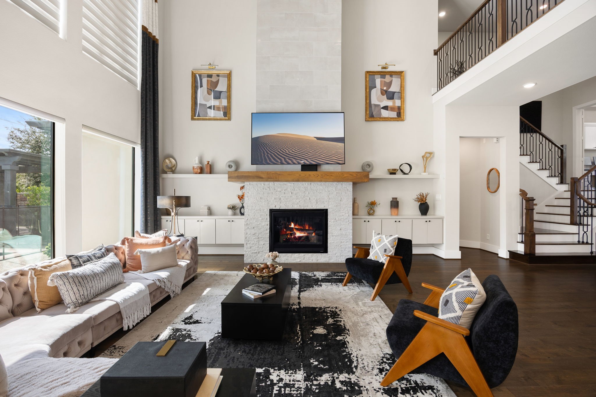 Inviting living room featuring a stunning fireplace, high ceilings, and an open, airy layout.