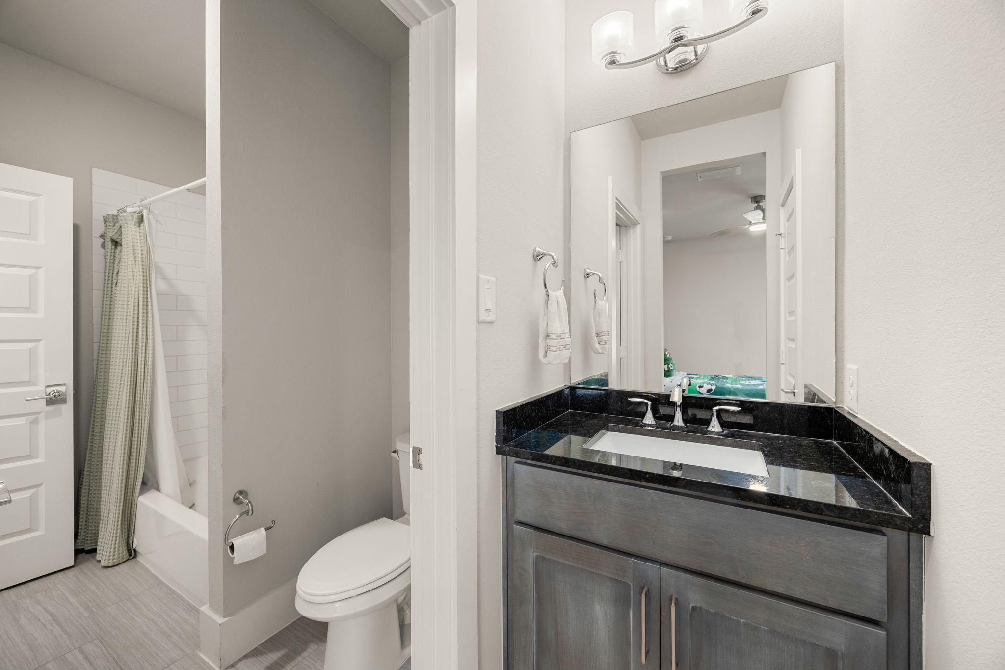 Convenient secondary jack and jill bathroom featuring a modern vanity, attractive countertop, and functional layout.