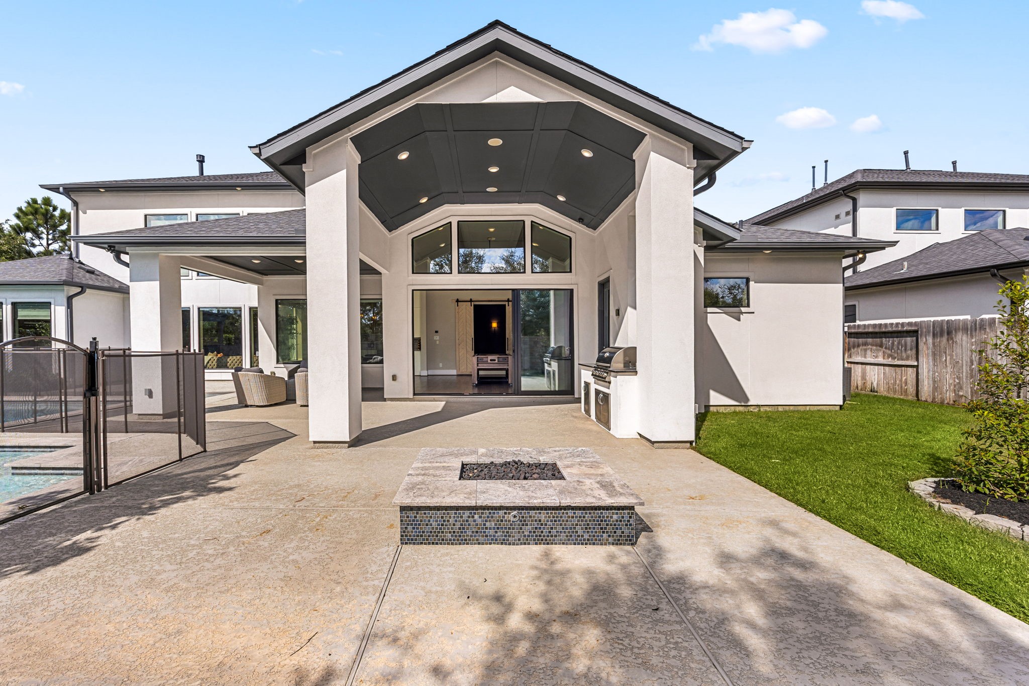Impressive outdoor entertaining area featuring a fire pit and resort-style surroundings.