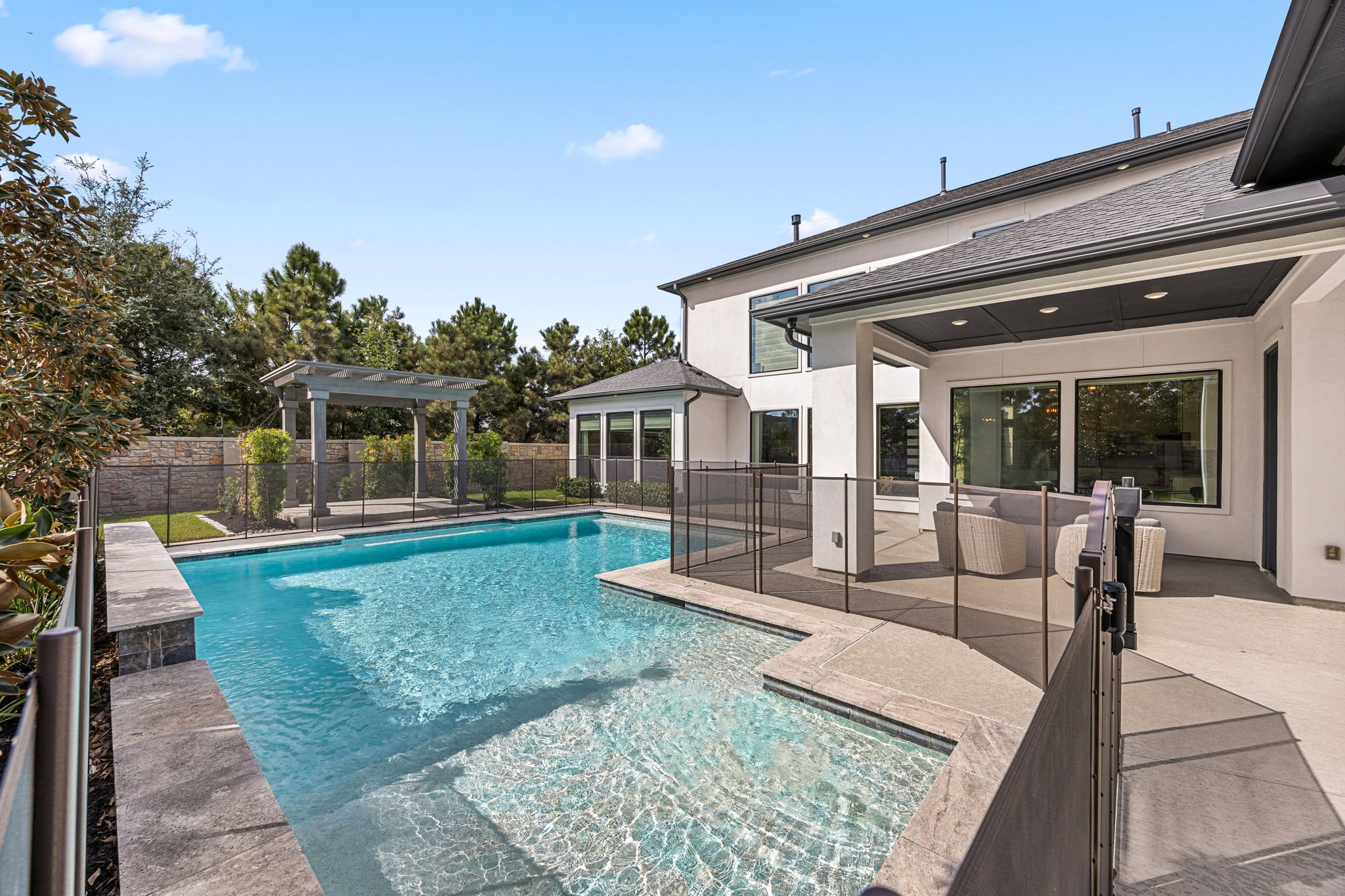 Stunning resort-style swimming pool surrounded by spacious decking, offering the perfect setting for relaxation and entertaining.