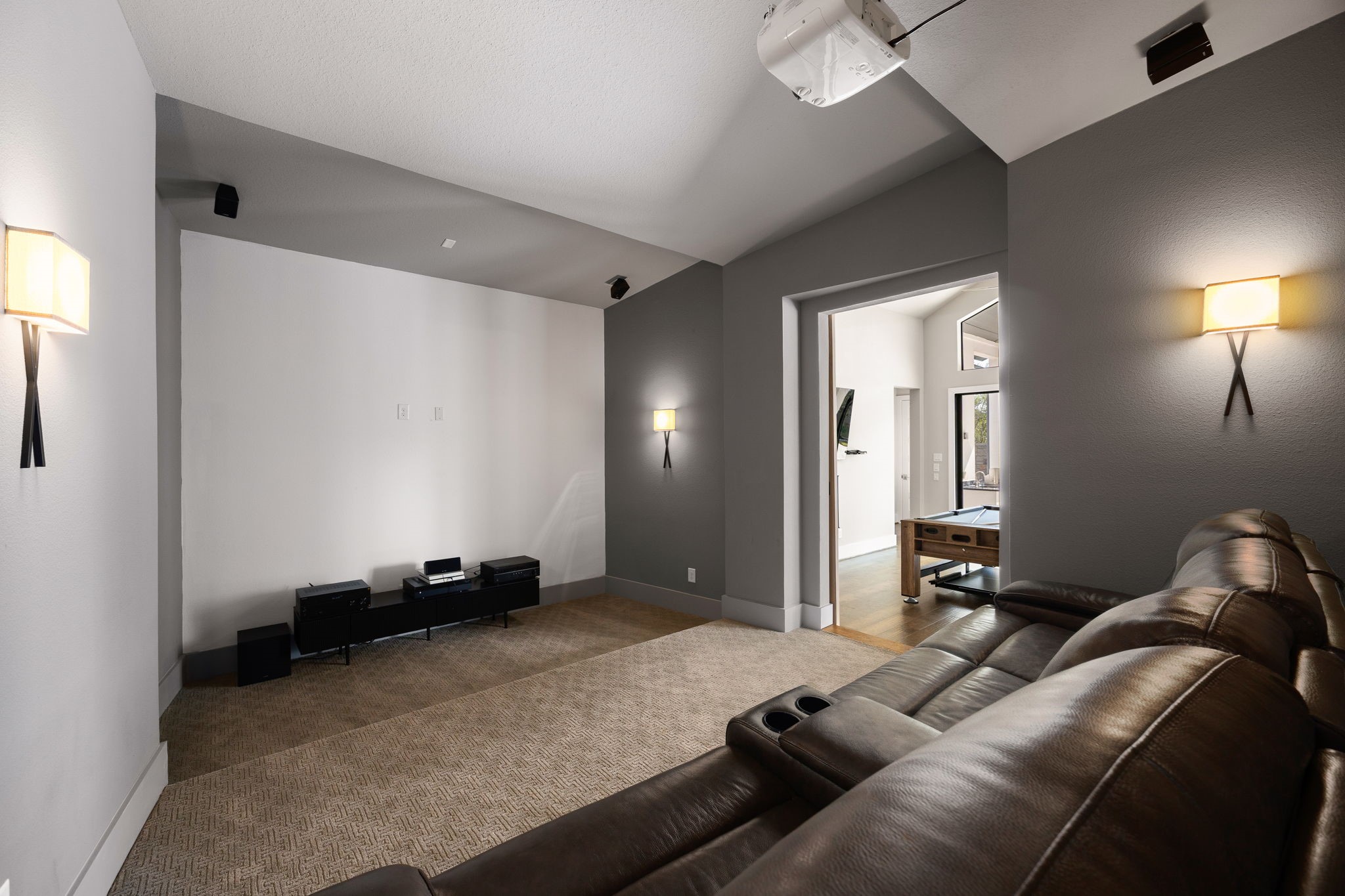 Spacious media room featuring a cozy, inviting atmosphere, perfect for movie nights, watching your favorite shows, or relaxing with family and friends.