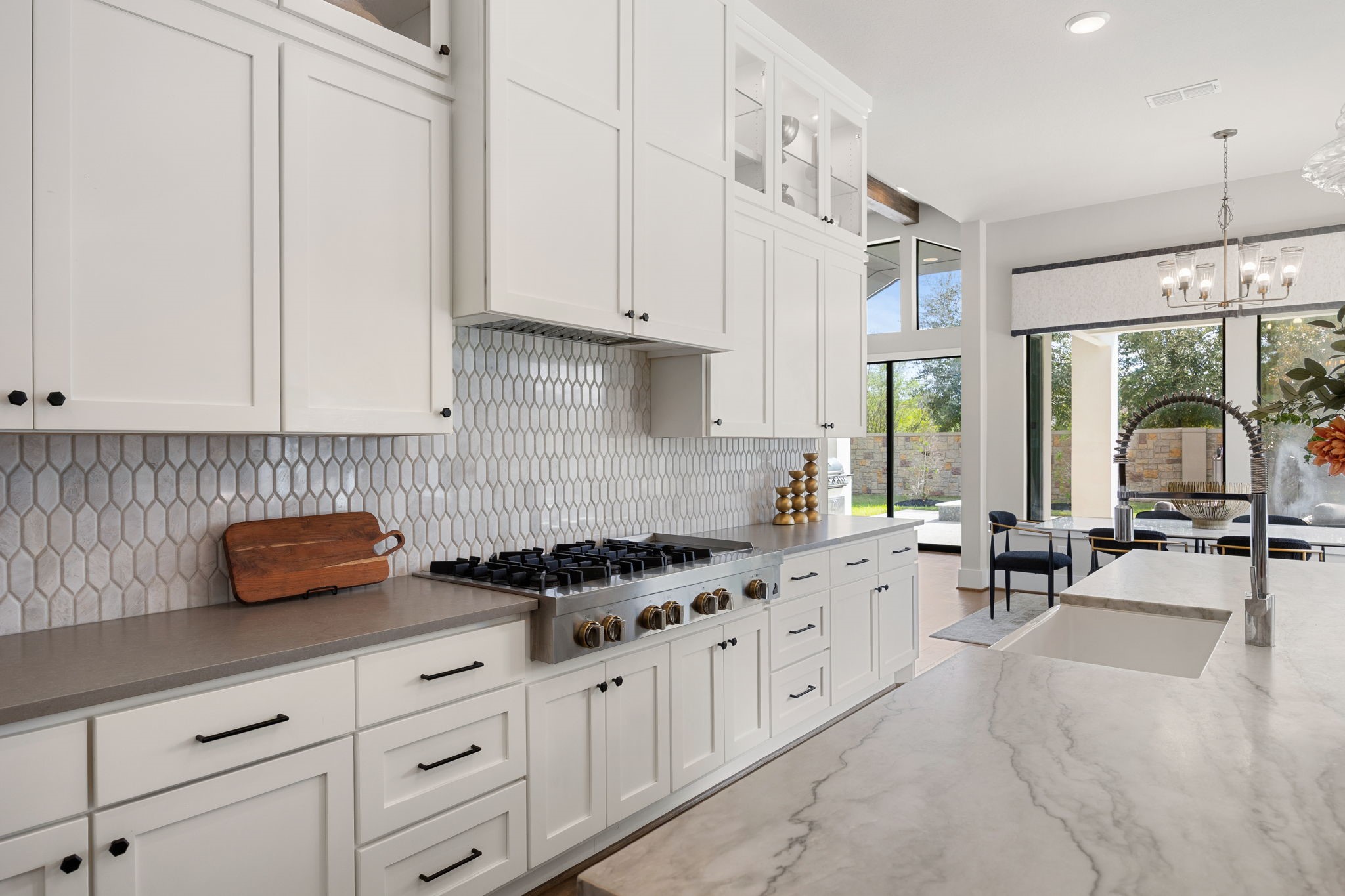 Beautifully appointed kitchen offering abundant cabinetry, generous counter space, and views of the backyard.