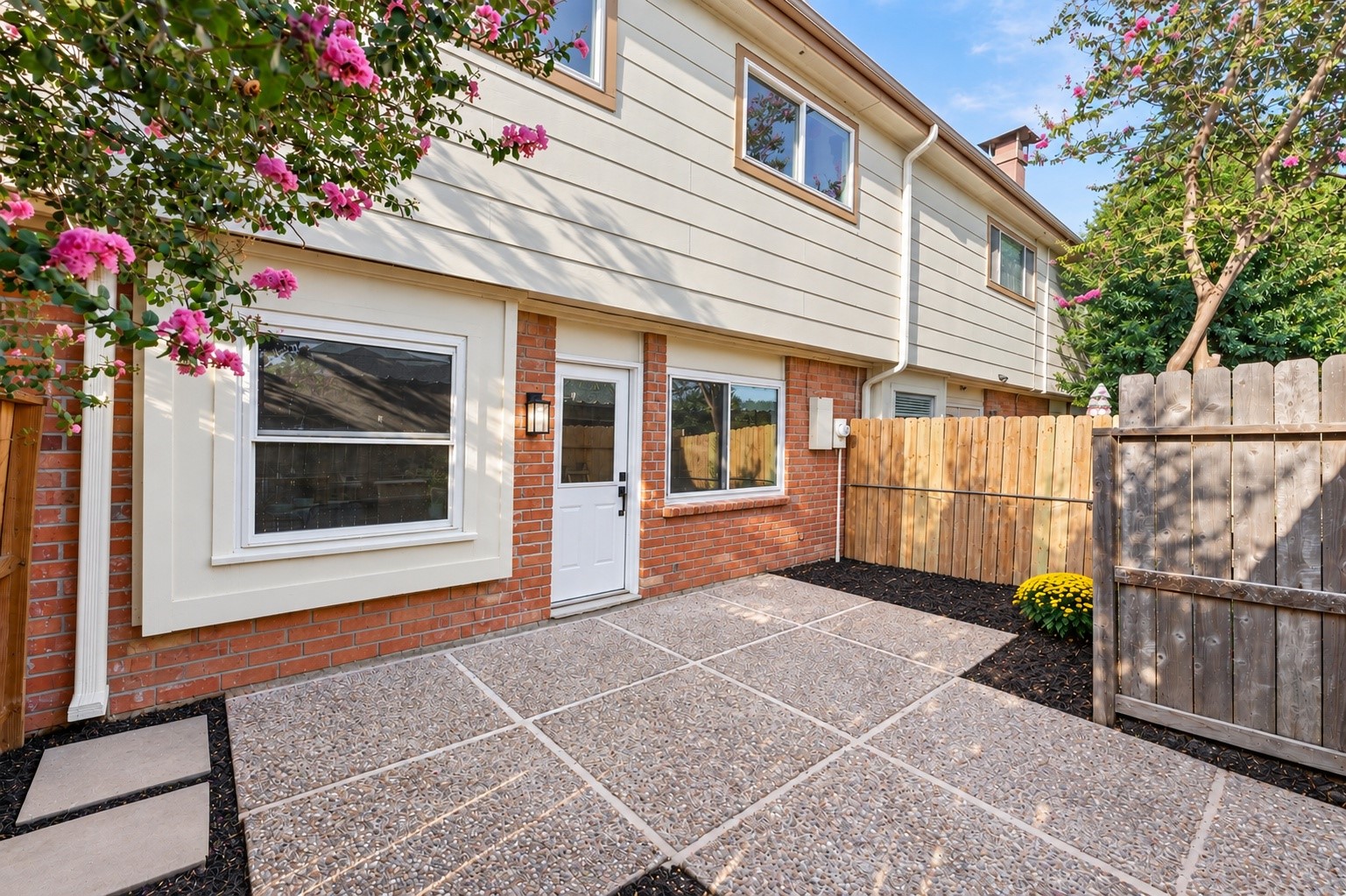 The outdoor patio, that leads to the covered carport with a shed for extra storage space.