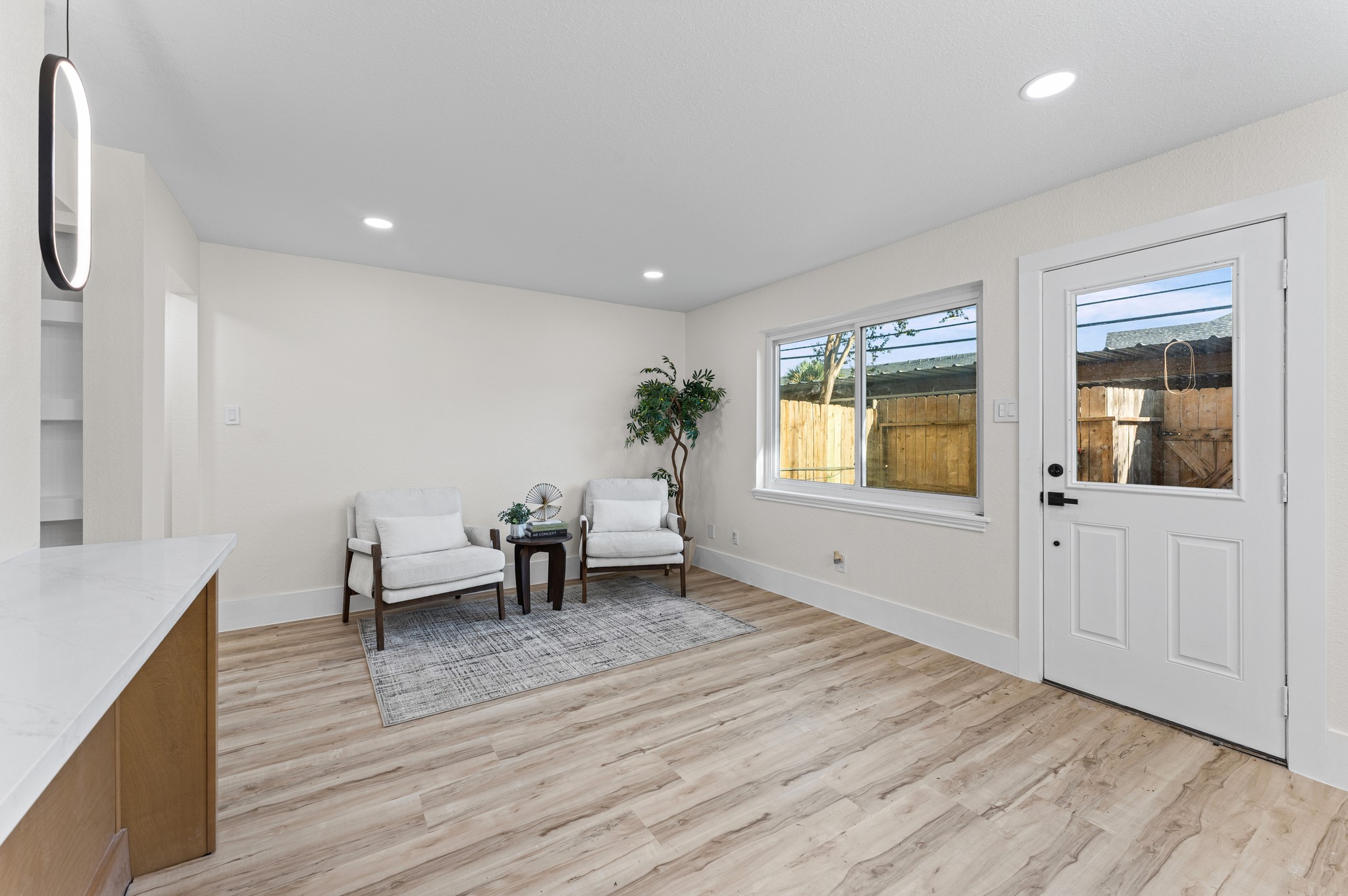 A view of the seating area when you first walk through the back door. There are washer and dryer hookups built in here as well.
