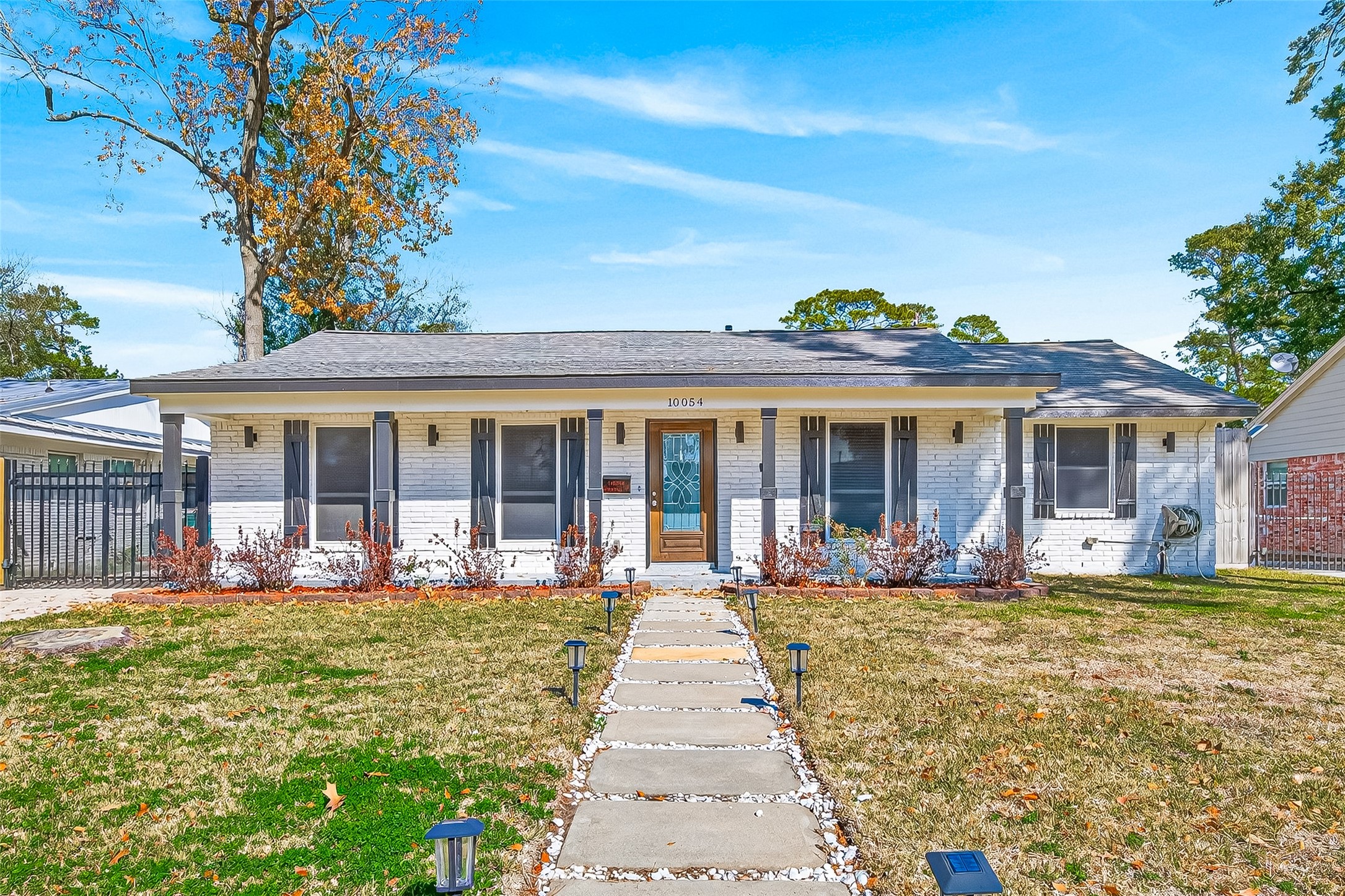Charming single-story home with a welcoming front porch and well-maintained landscaping.