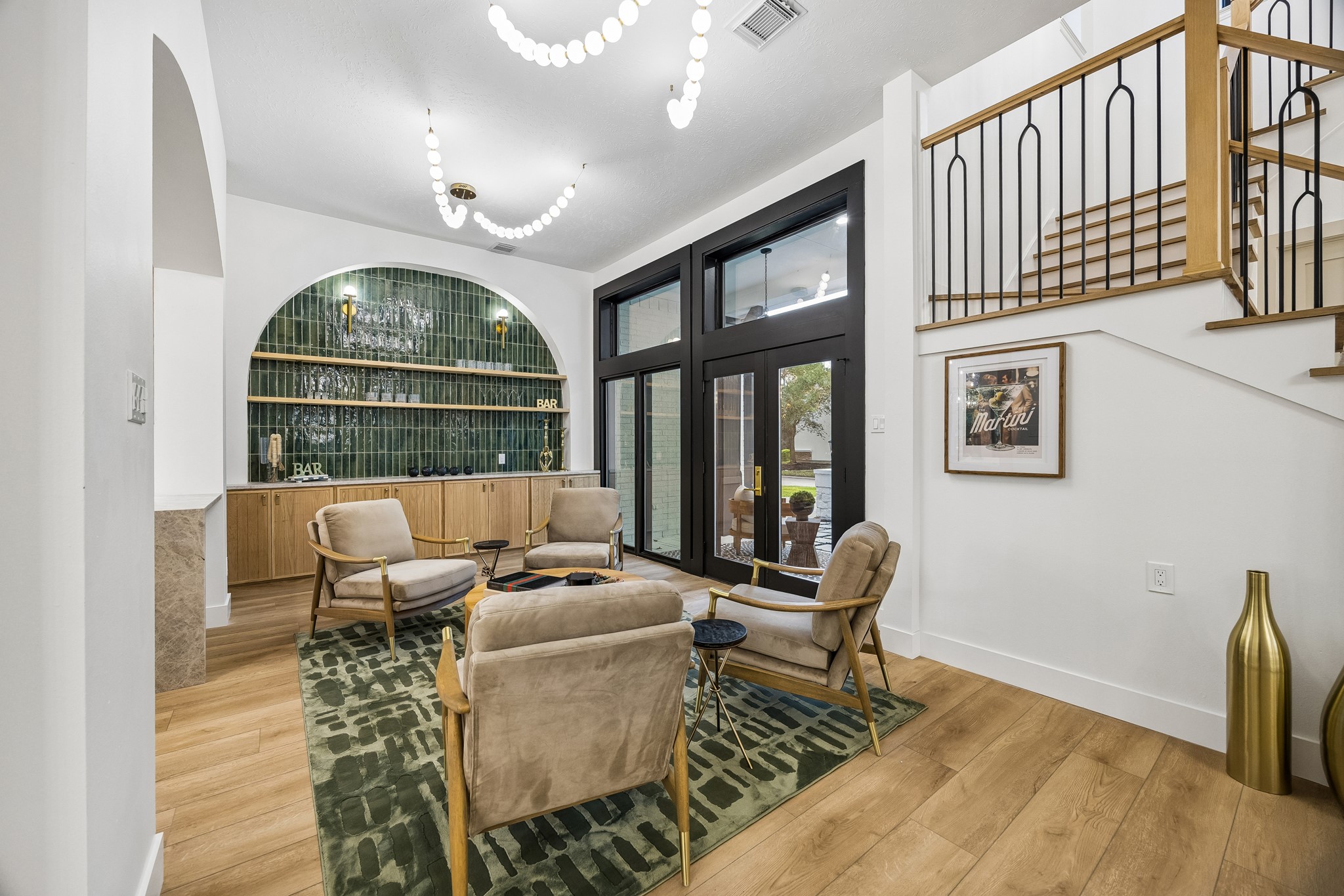 Stunning green tile accent the bar area, large french doors take you to your front porch courtyard