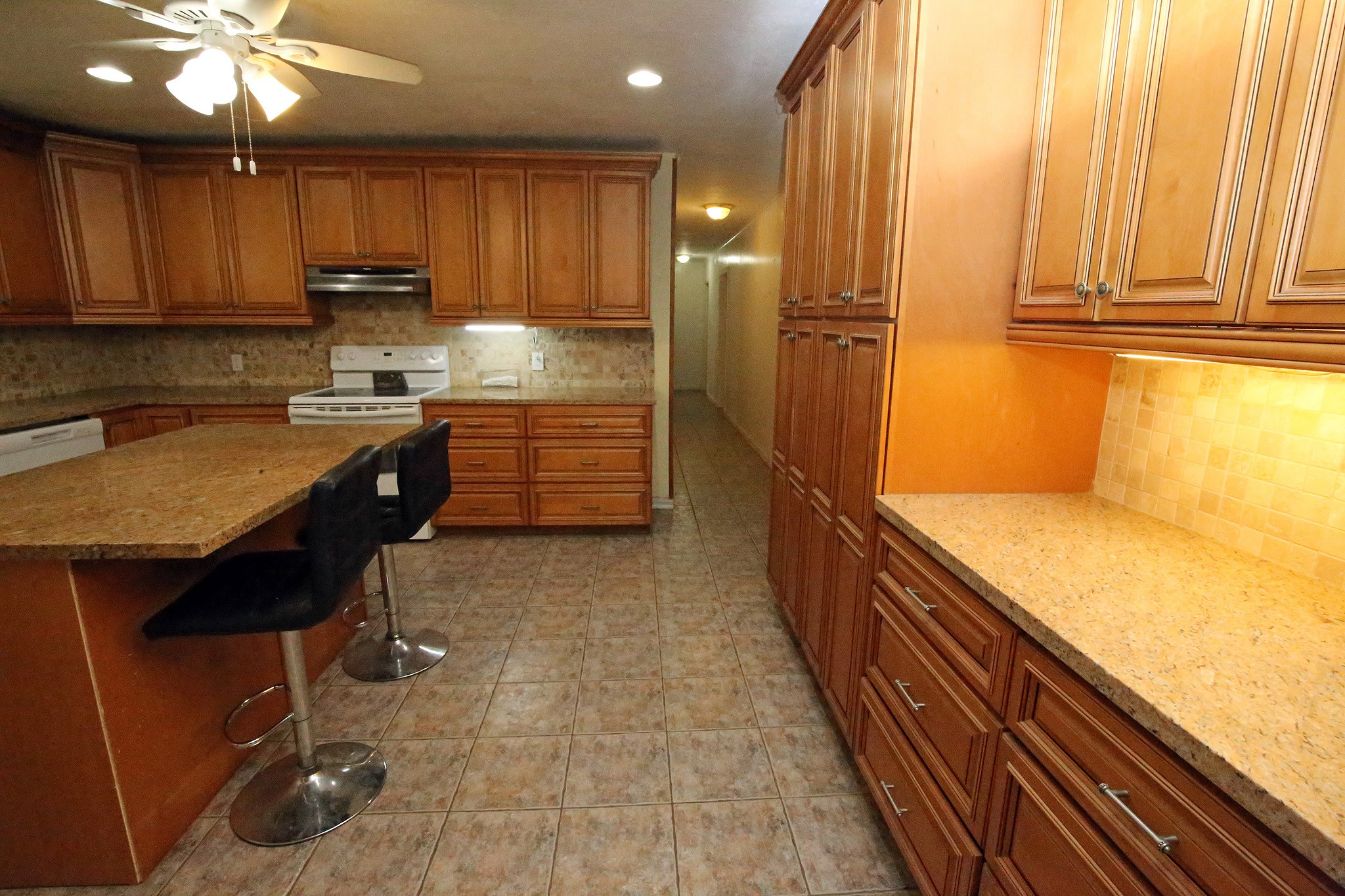 Kitchen with tile flooring, granite countertops and island bar!
