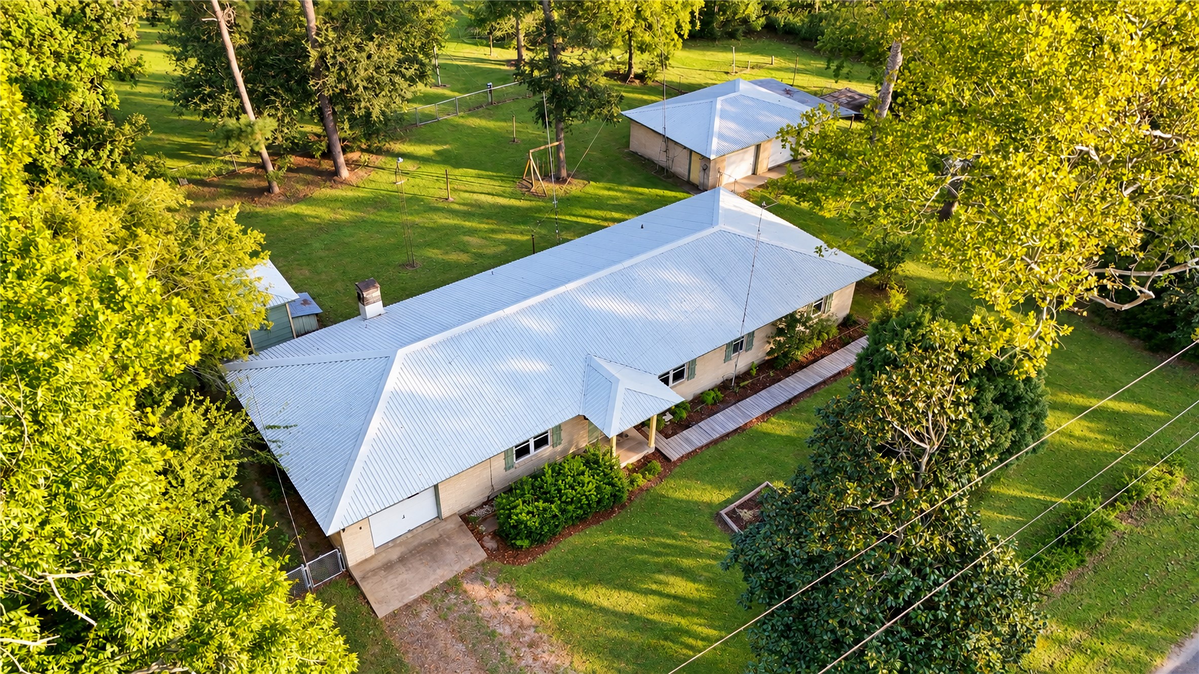 Aerial View of the House, Detached Garage and the Pump Shed.