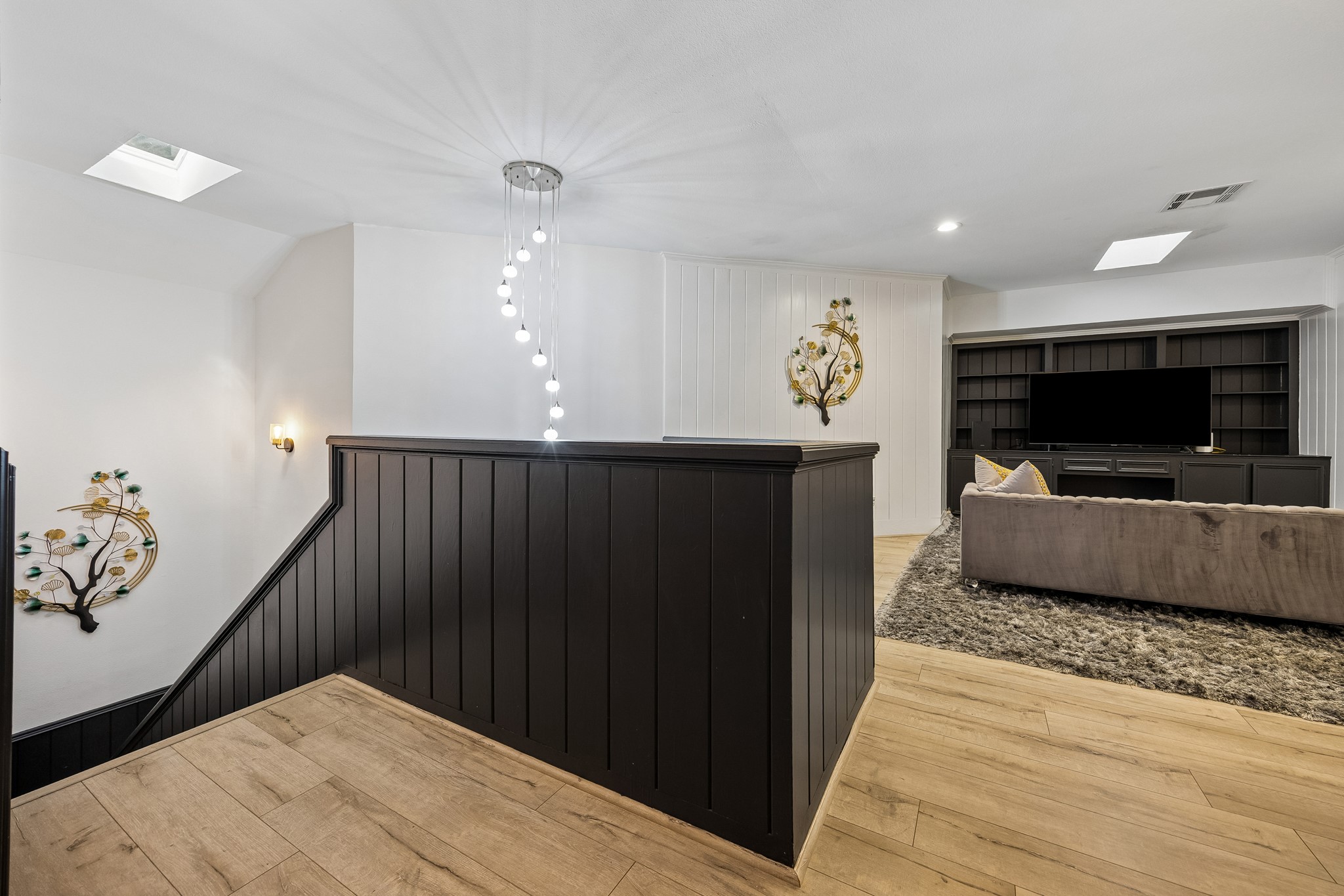 The second floor features three bedrooms with ensuite baths and entertainment area.